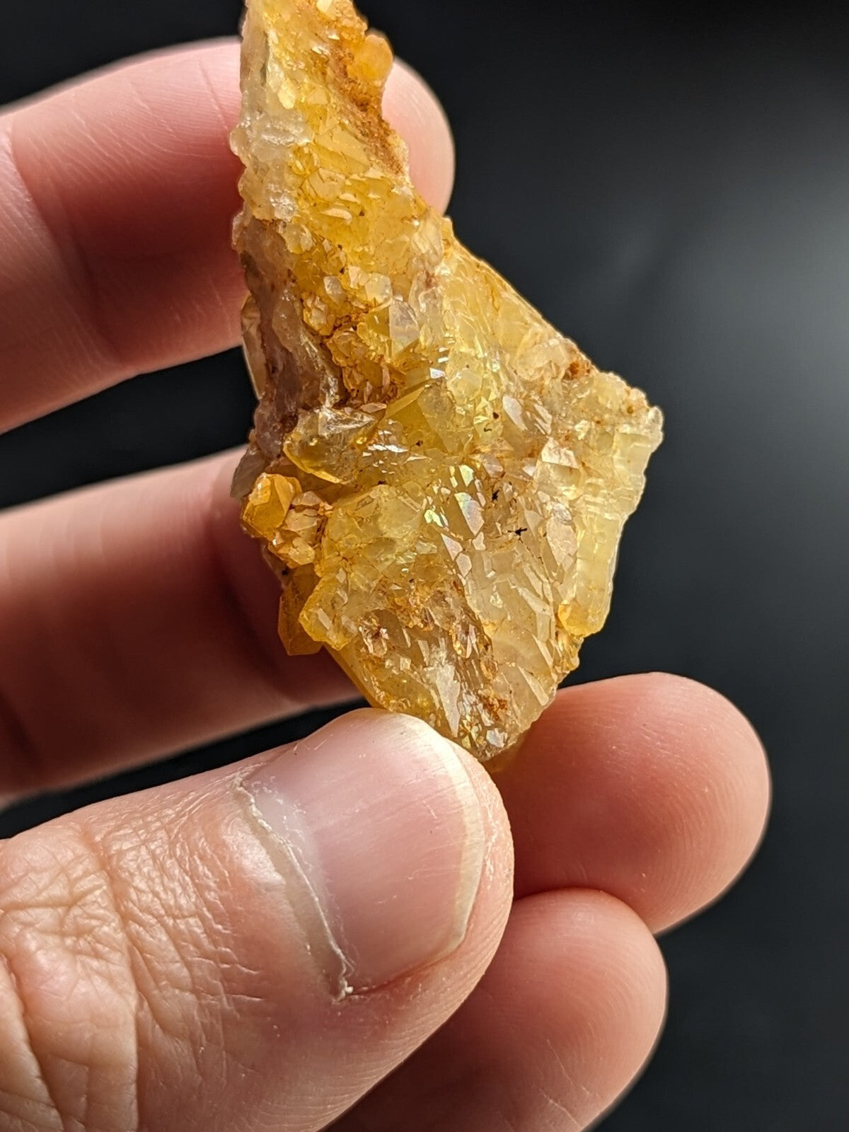 A translucent golden-yellow crystal cluster with sharp, faceted edges and a rough, natural texture.