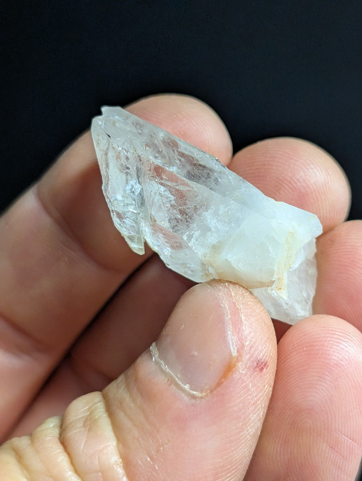 A translucent, crystalline quartz specimen with jagged edges and a pale, milky white hue.