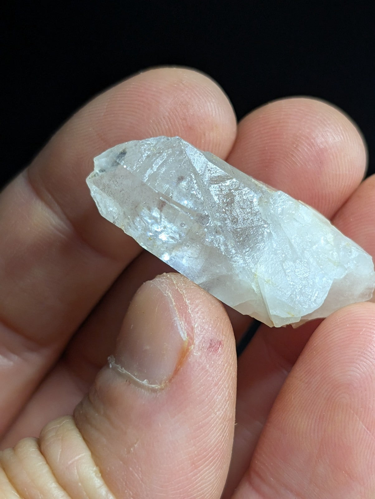 A translucent, pale quartz crystal with natural facets and subtle internal inclusions.