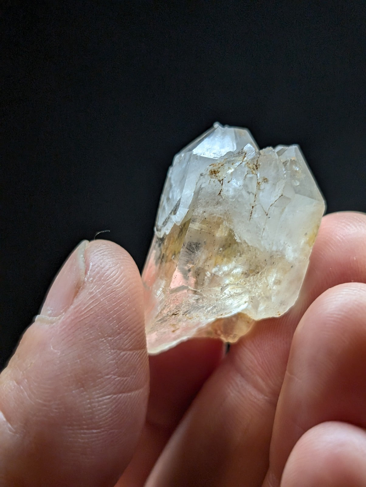 A translucent, pale yellowish quartz crystal cluster with clear facets and subtle internal inclusions.