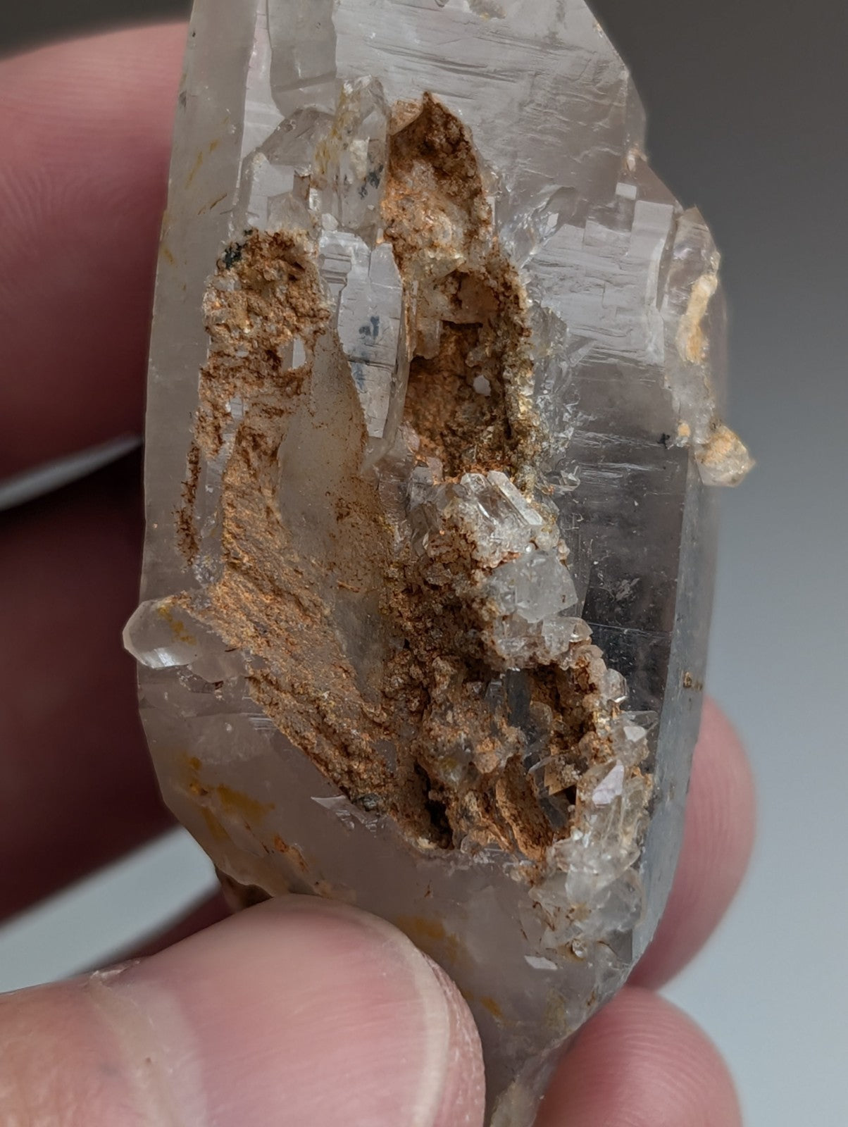Unique quartz crystal with nacrite inclusions featuring a translucent brownish rough surface from montgomery county arkansas