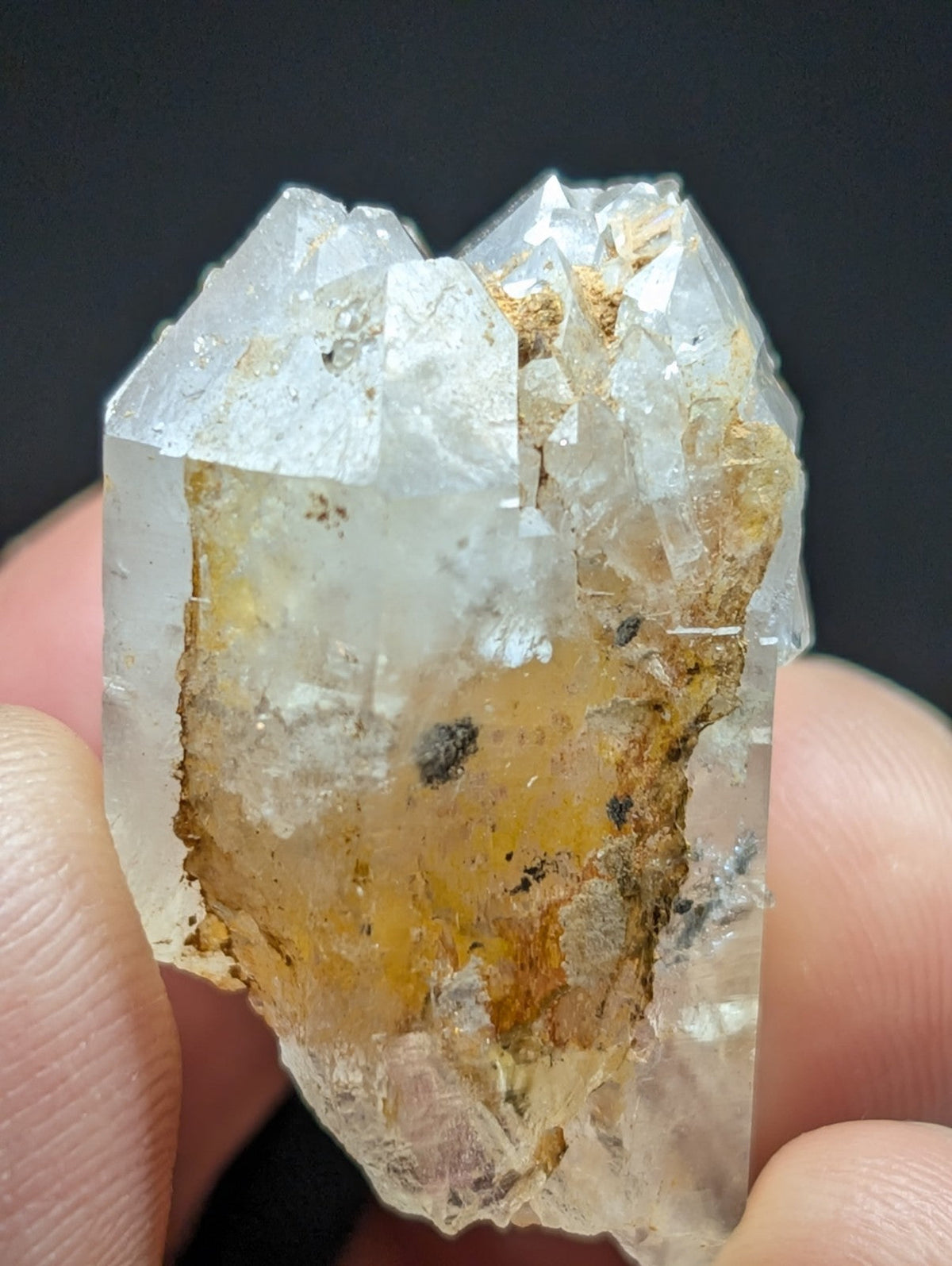 A translucent quartz crystal cluster with a clear, glassy appearance and golden-yellow inclusions.