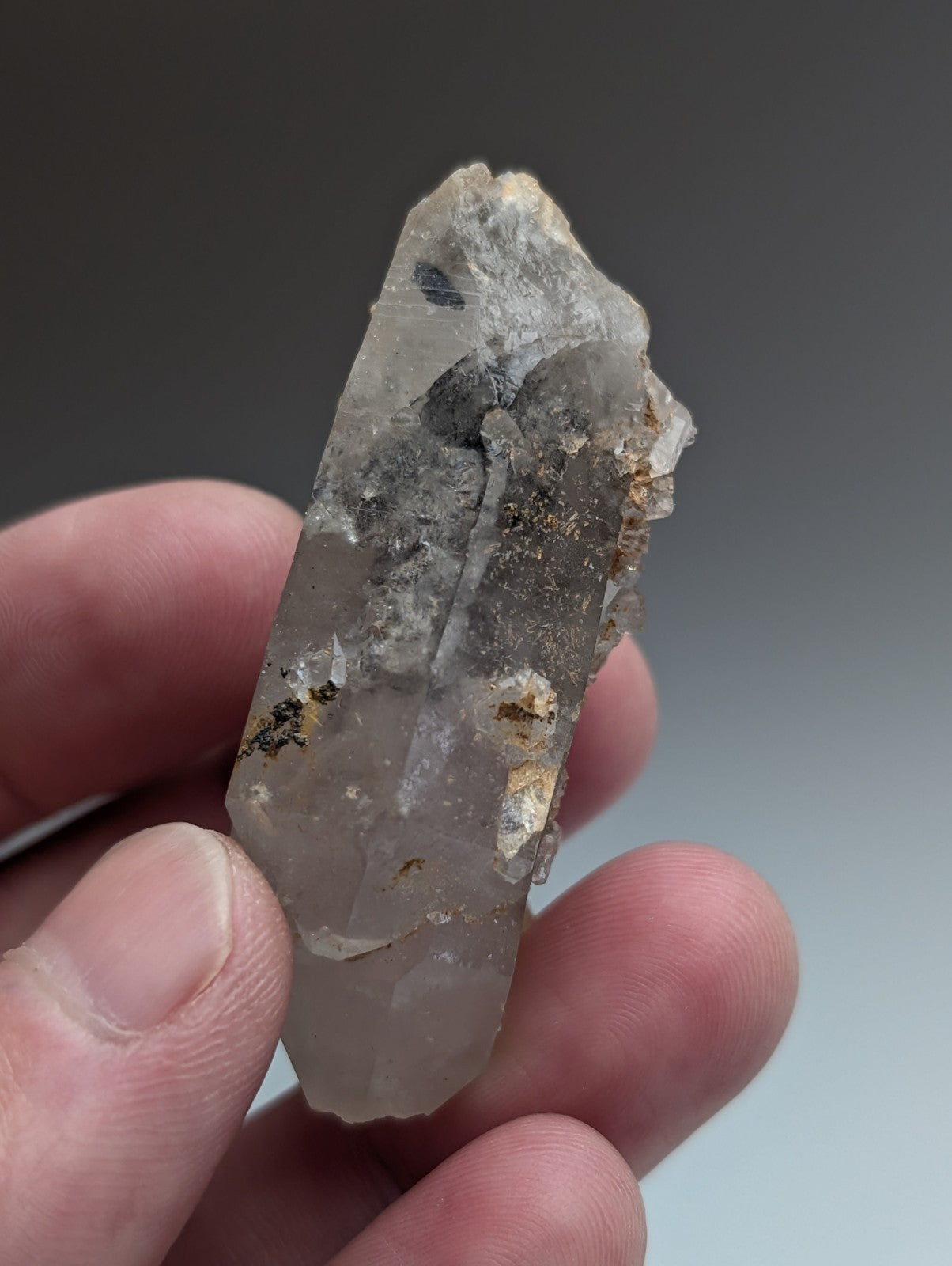 Unique clear quartz crystal with nacrite inclusions and earthy mineral deposits from Montgomery County Arkansas USA