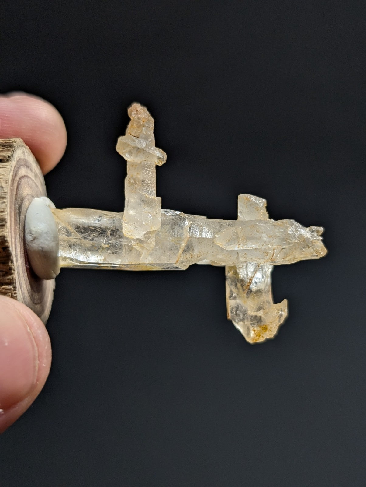 A translucent, crystalline key with a natural, jagged texture and pale yellowish hue.