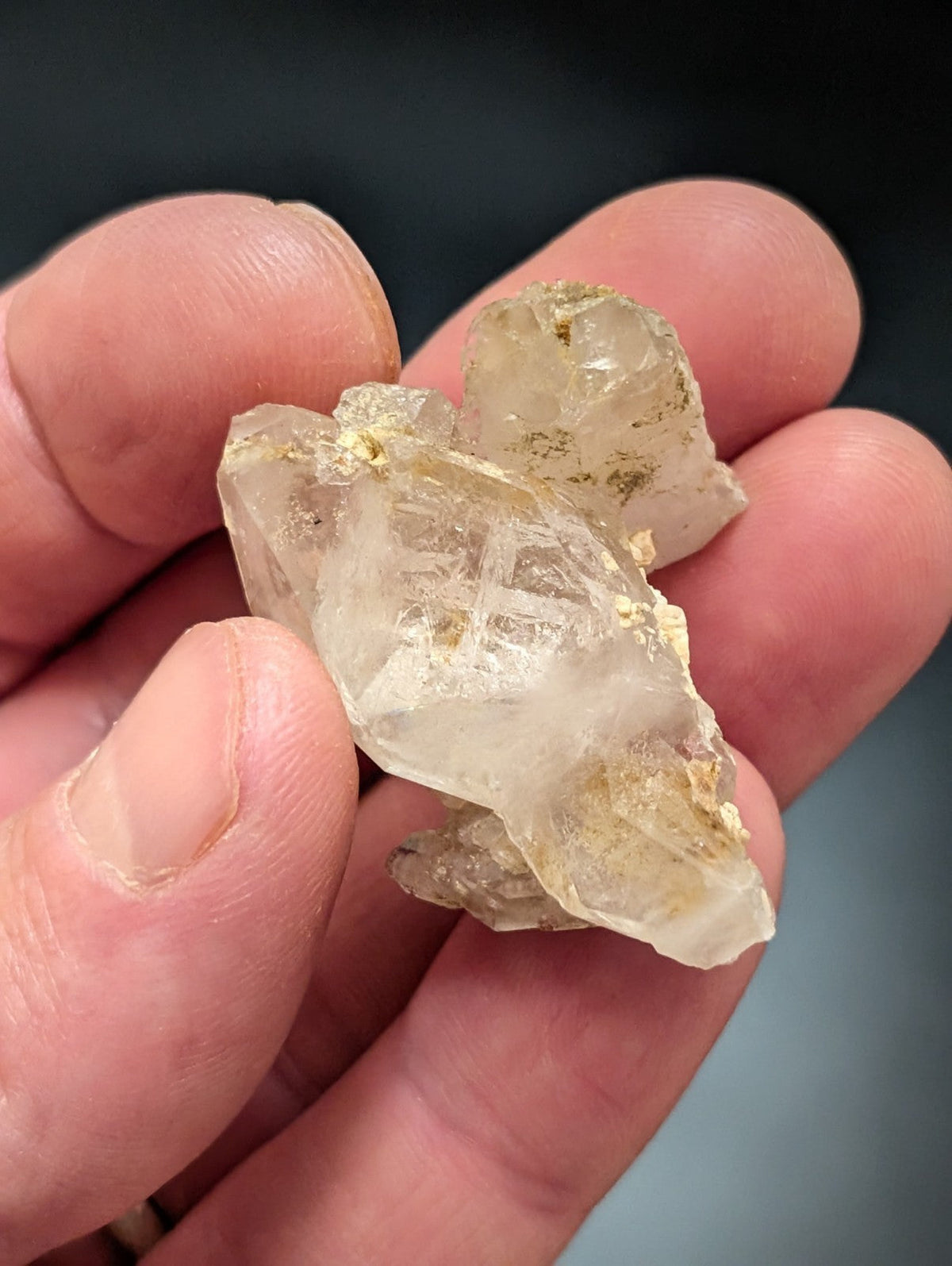 A translucent, pale yellowish quartz crystal cluster with golden mineral inclusions.