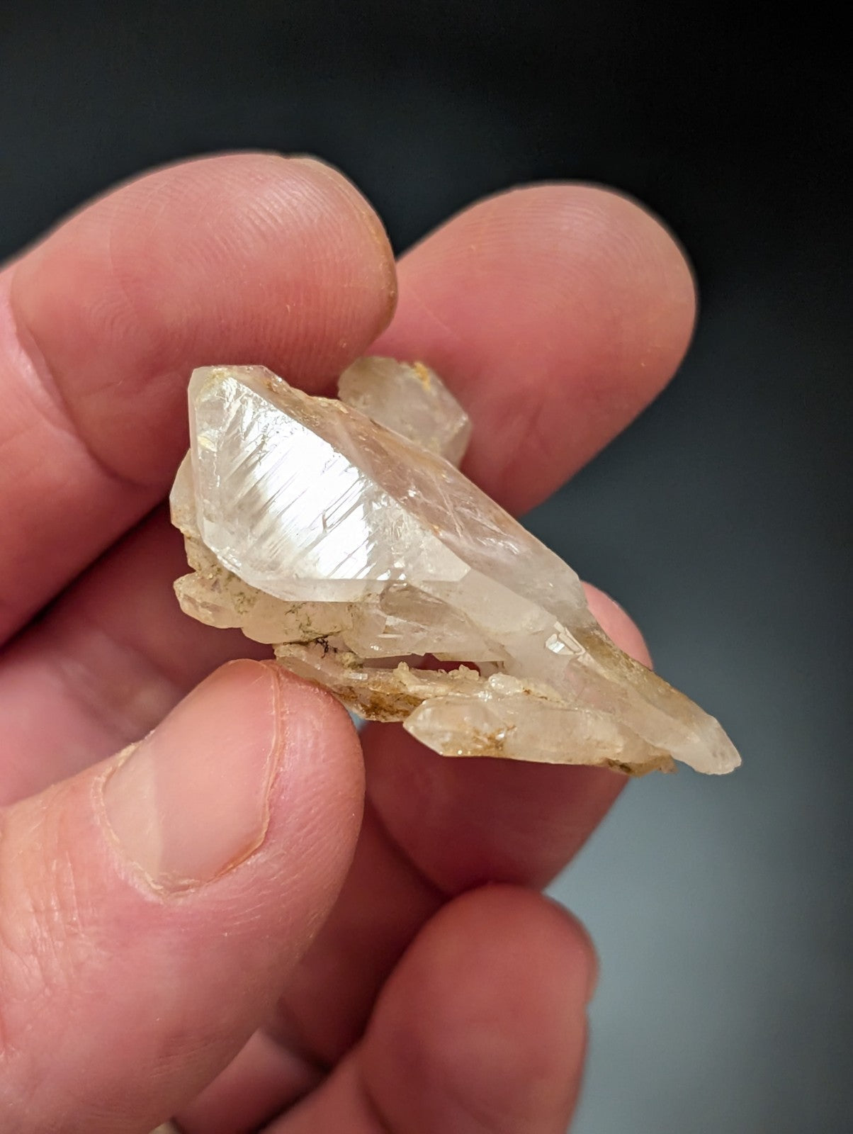 A translucent, pale yellow quartz crystal with sharp facets and a natural, irregular shape.