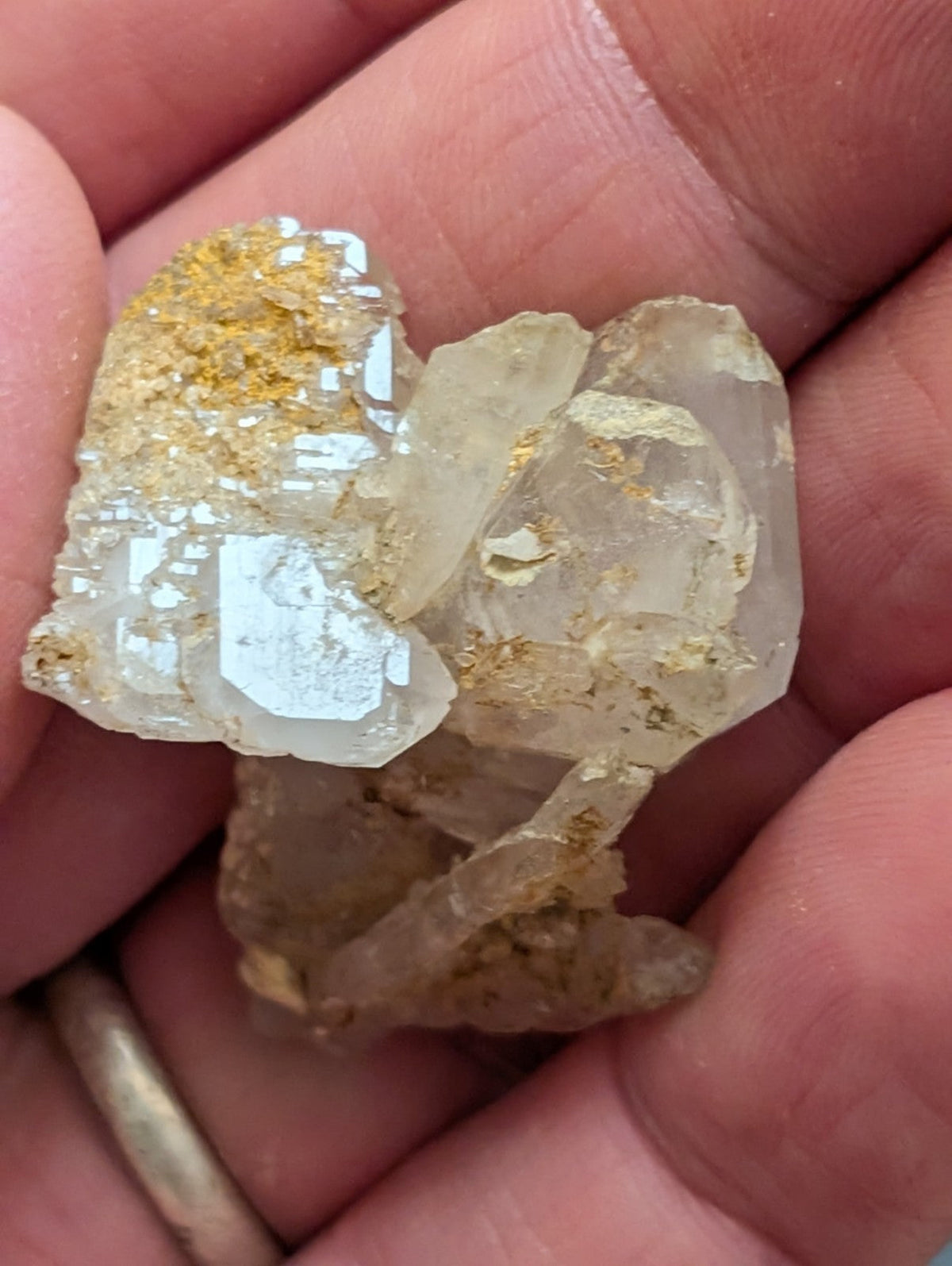 A translucent, crystalline mineral specimen with golden flecks embedded in its structure.