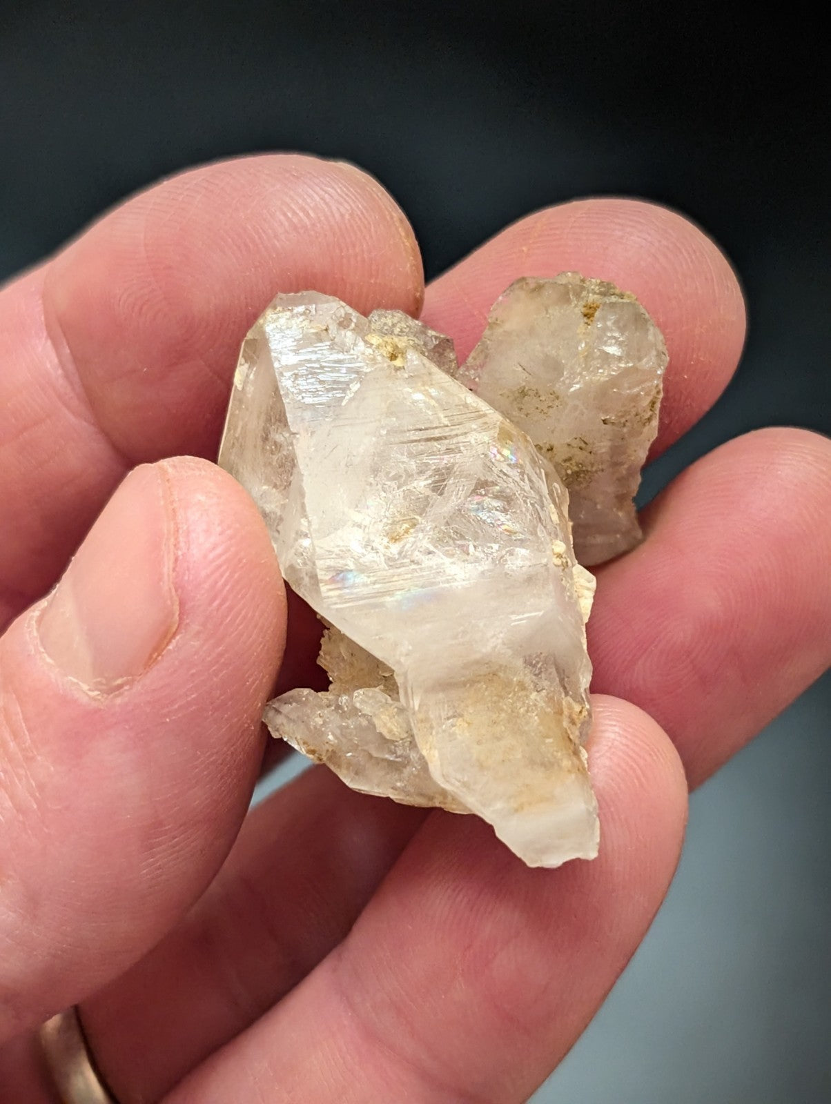 A translucent, pale quartz crystal cluster with visible internal striations and a few faint yellowish inclusions.