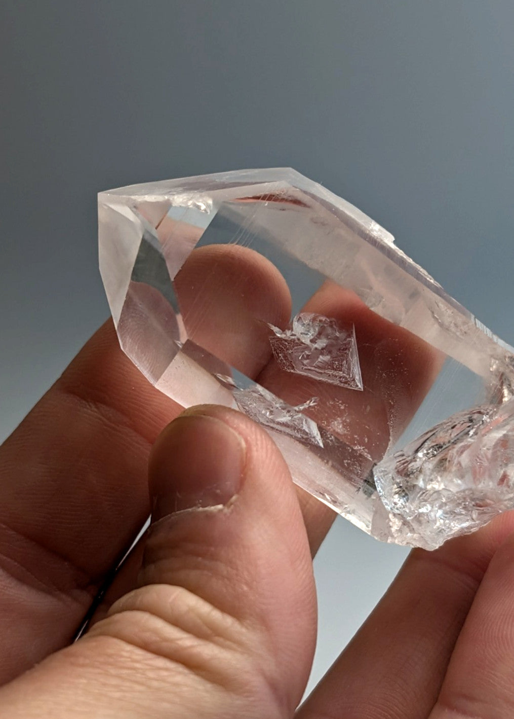 A clear faceted quartz crystal point with natural inclusions and a pointed tip from arkansas usa old stock a+ grade