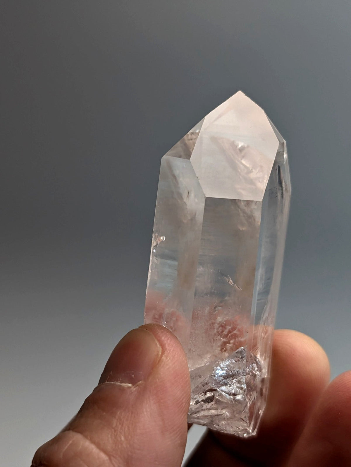 A clear transparent quartz crystal point with a faceted pointed top from arkansas usa old stock a plus grade