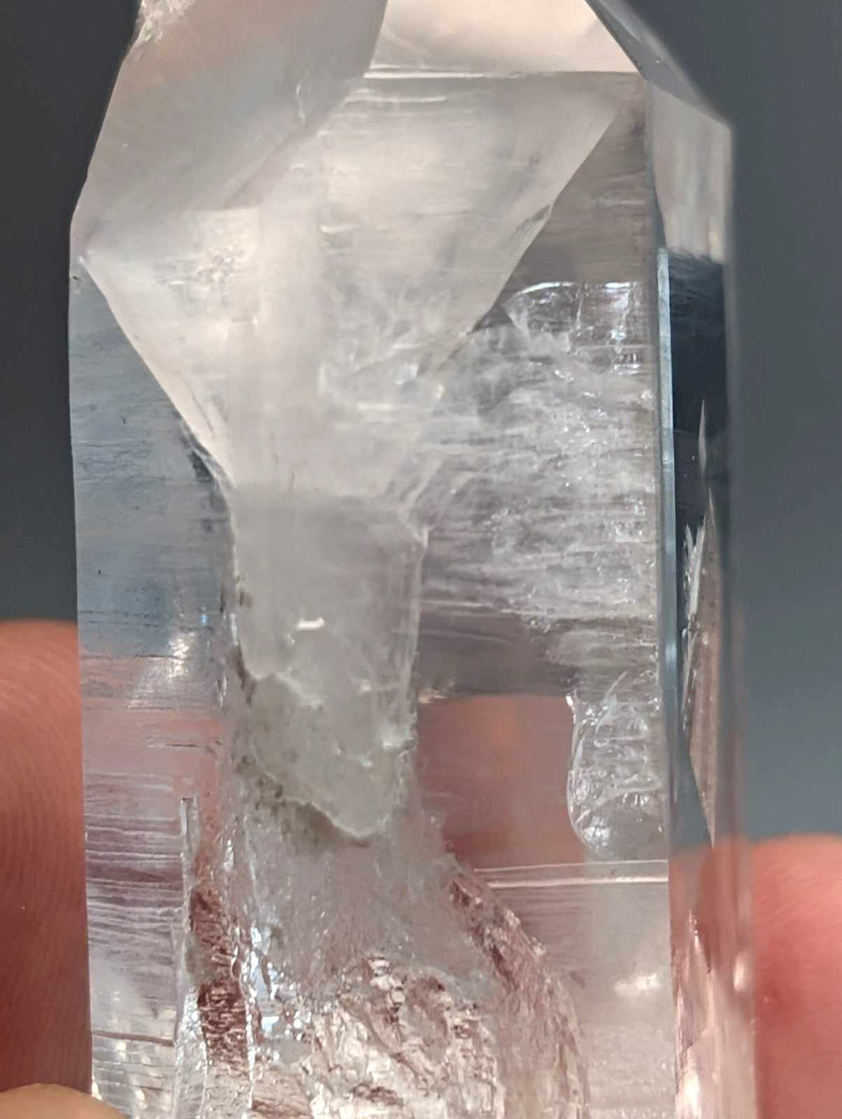 Unique quartz crystal point from arkansas usa with clear faceted top and natural internal striations a plus grade