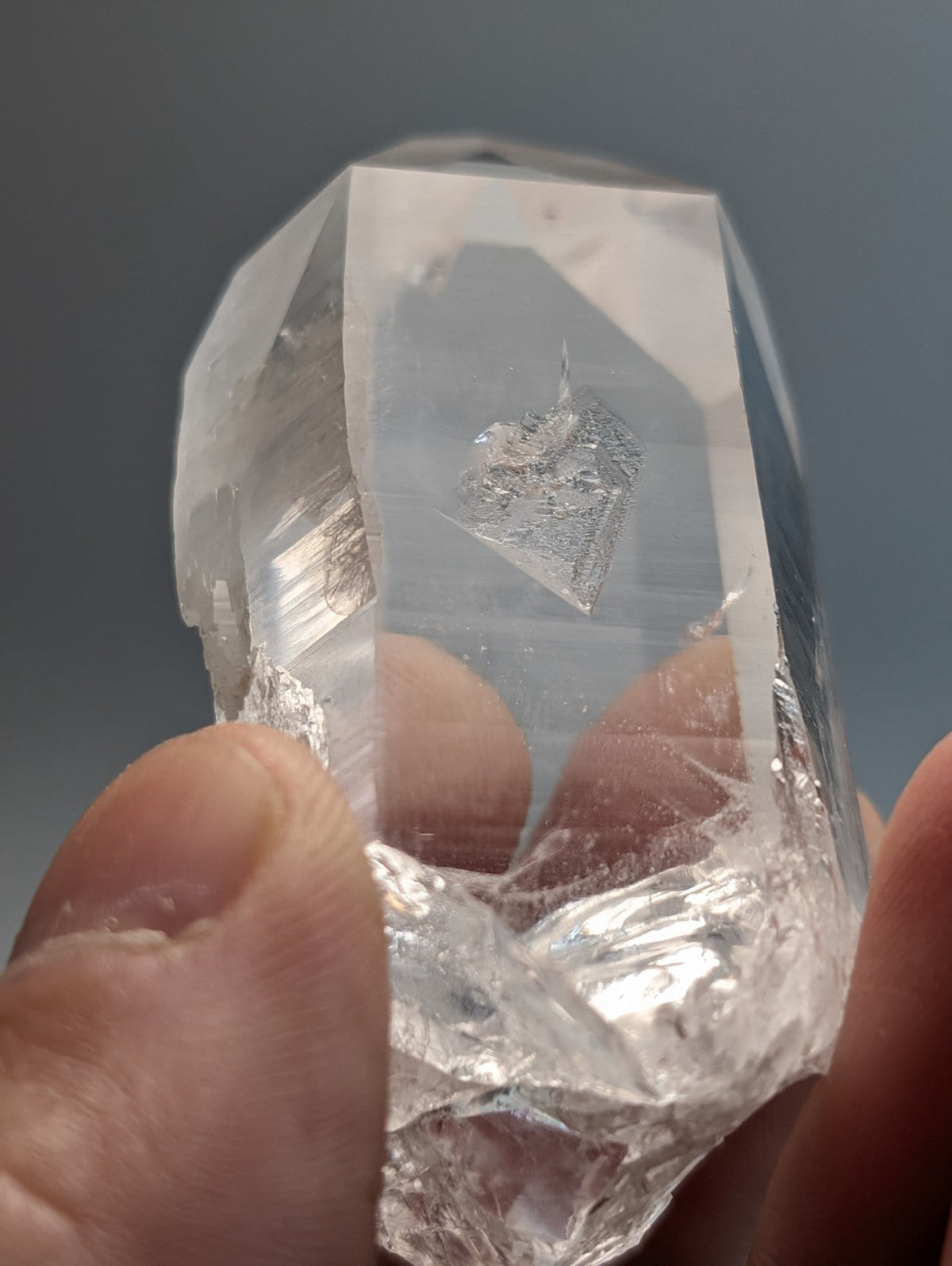 A unique faceted quartz crystal point with a rough base from Arkansas usa water clear A plus grade