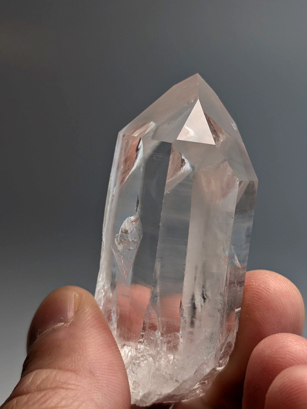 A clear transparent quartz crystal point with natural facets from unique old stock in arkansas usa a plus grade