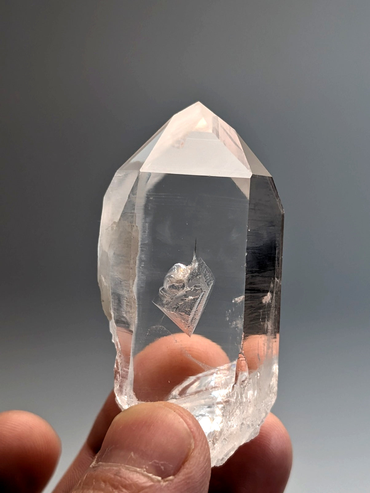 A clear faceted quartz crystal point with natural inclusions from old stock Arkansas usa A plus grade water clear