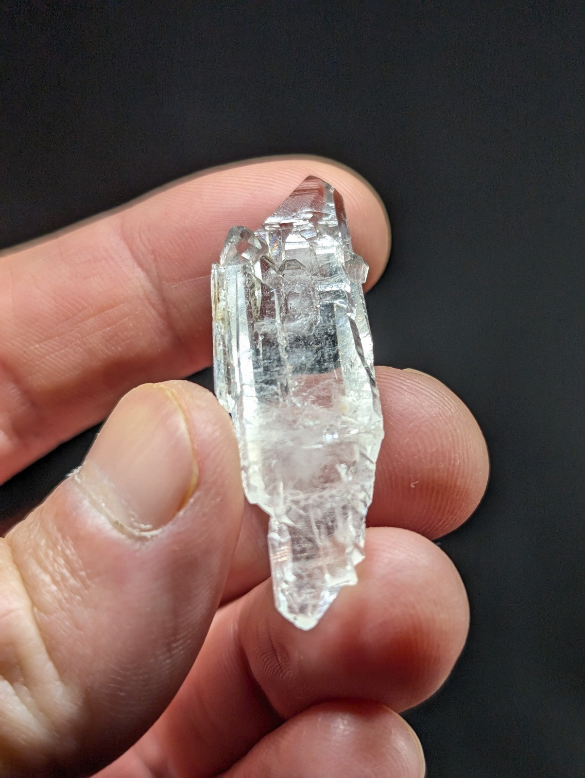A clear, translucent quartz crystal cluster with sharp facets and a natural, jagged form.