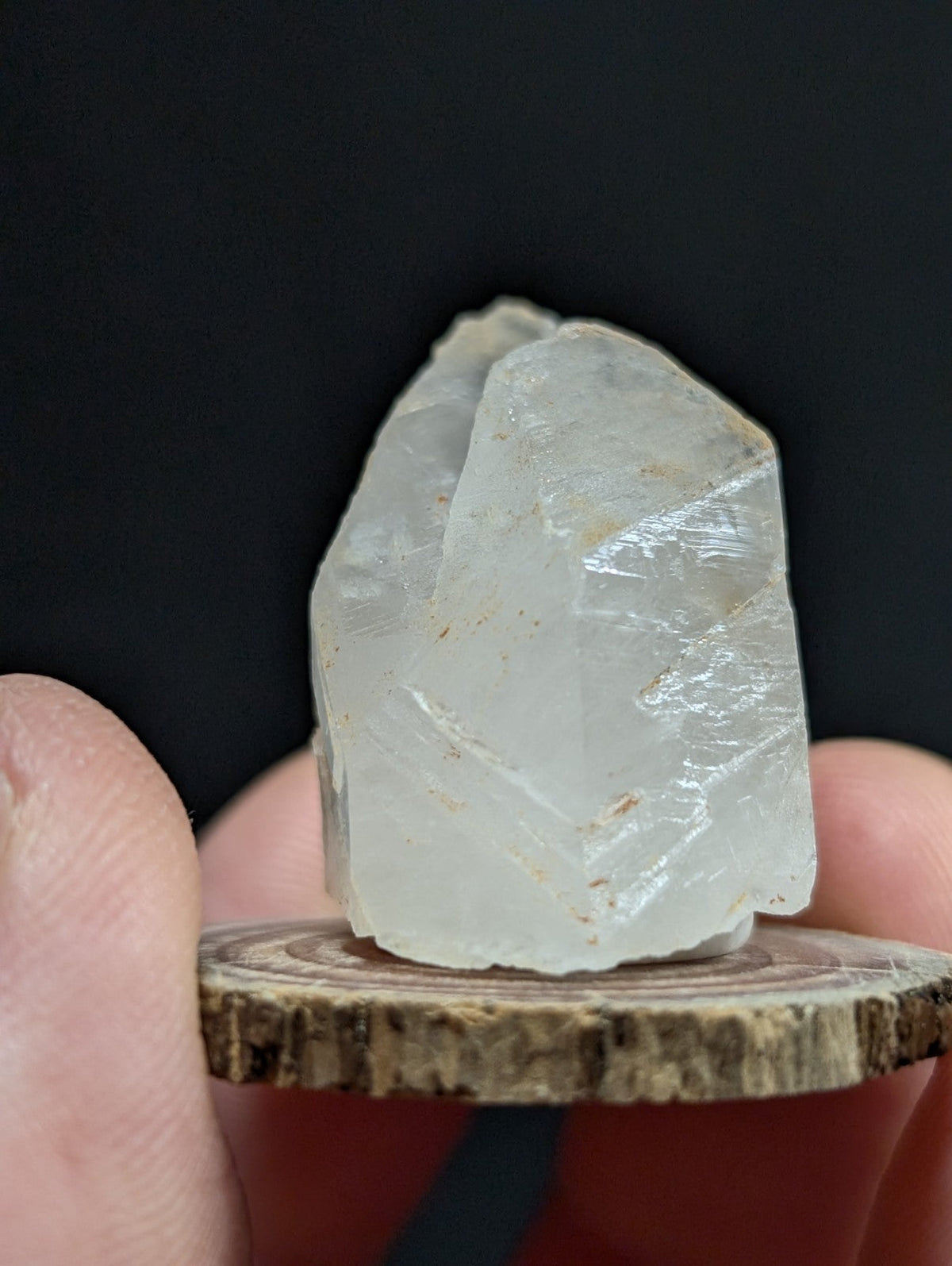 A translucent, pale quartz crystal with natural facets and subtle internal striations.