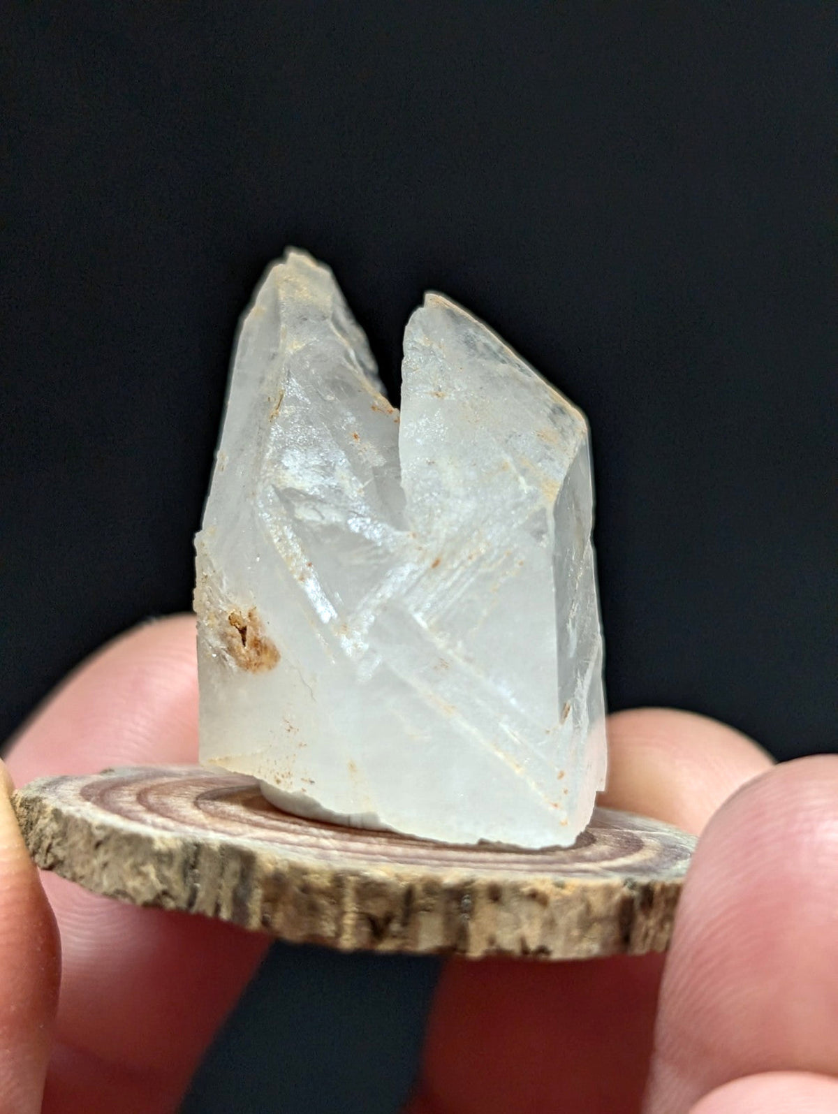 A translucent, pale quartz crystal with sharp facets and a natural, slightly rough texture.