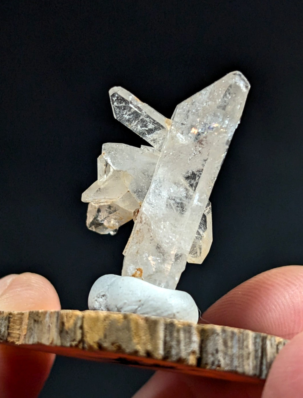 A clear quartz crystal cluster with sharp, translucent points and natural inclusions.