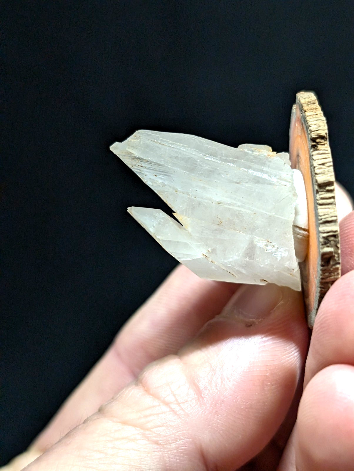 A translucent, pale quartz crystal cluster with sharp facets and a natural, slightly rough texture.