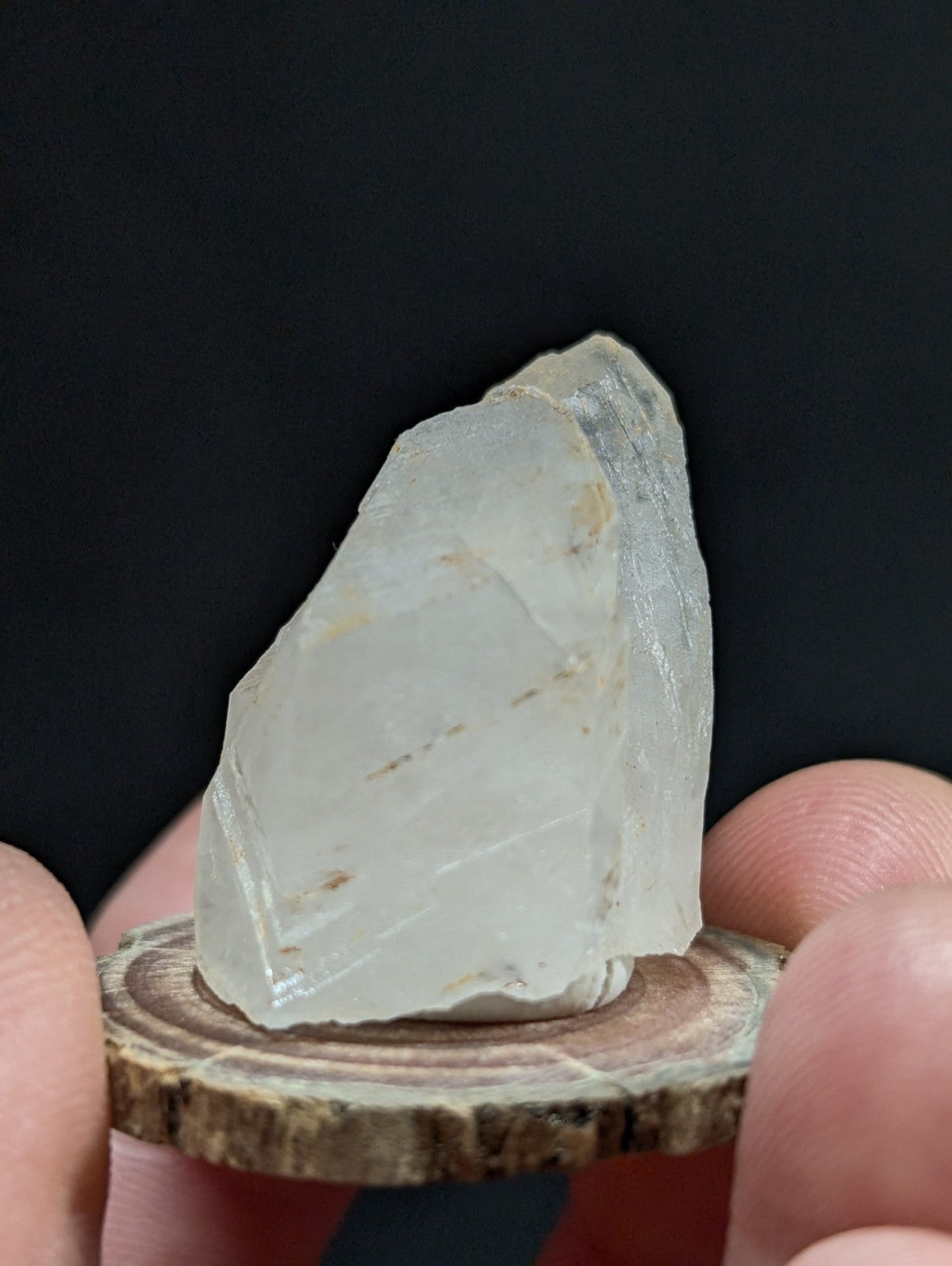 A translucent, pale quartz crystal with natural facets and subtle internal inclusions.