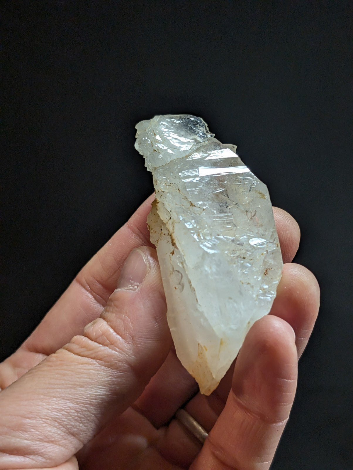 A translucent, pale quartz crystal with natural facets and subtle internal striations.