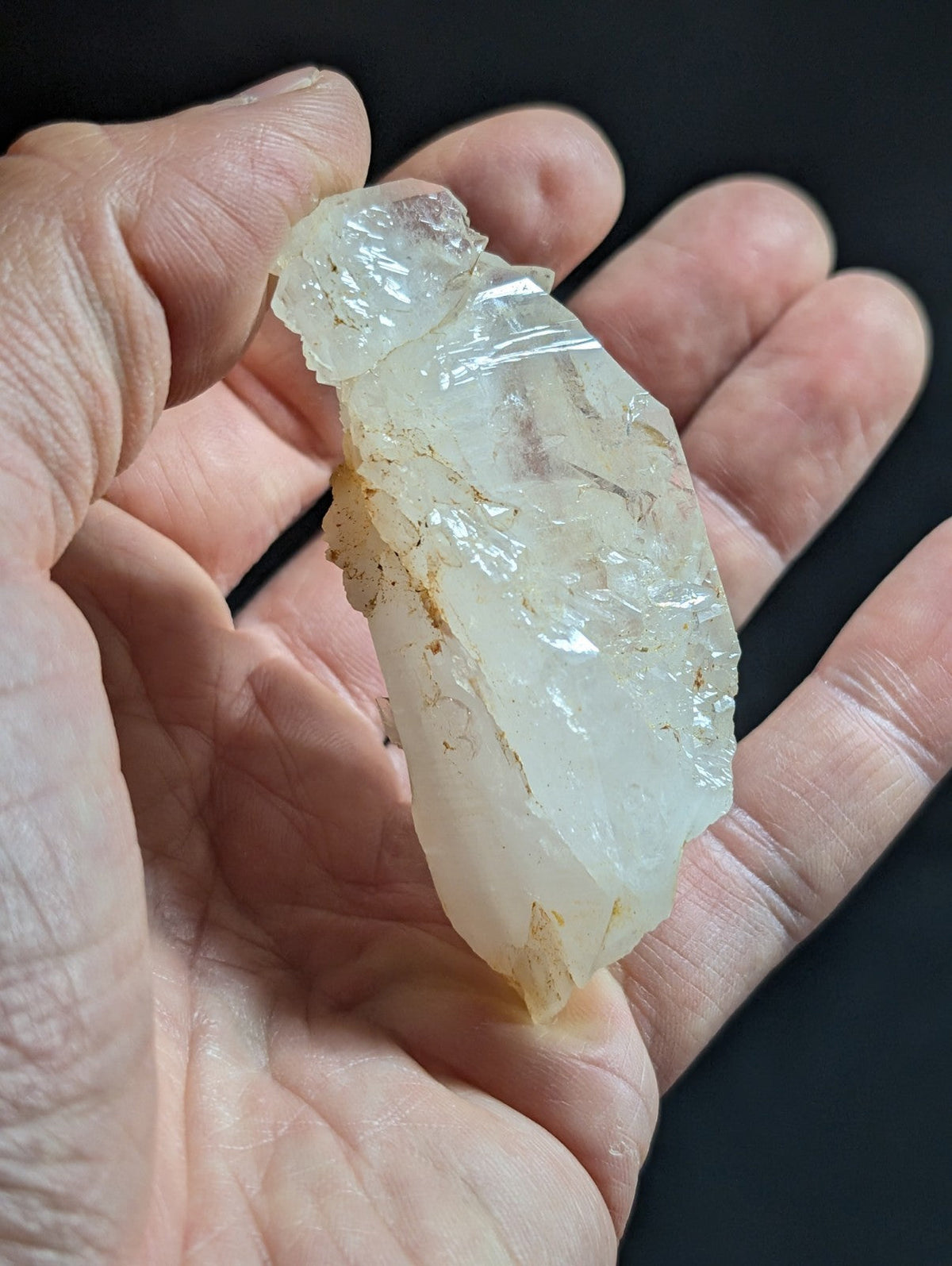 A translucent, pale white quartz crystal with natural facets and subtle internal inclusions.