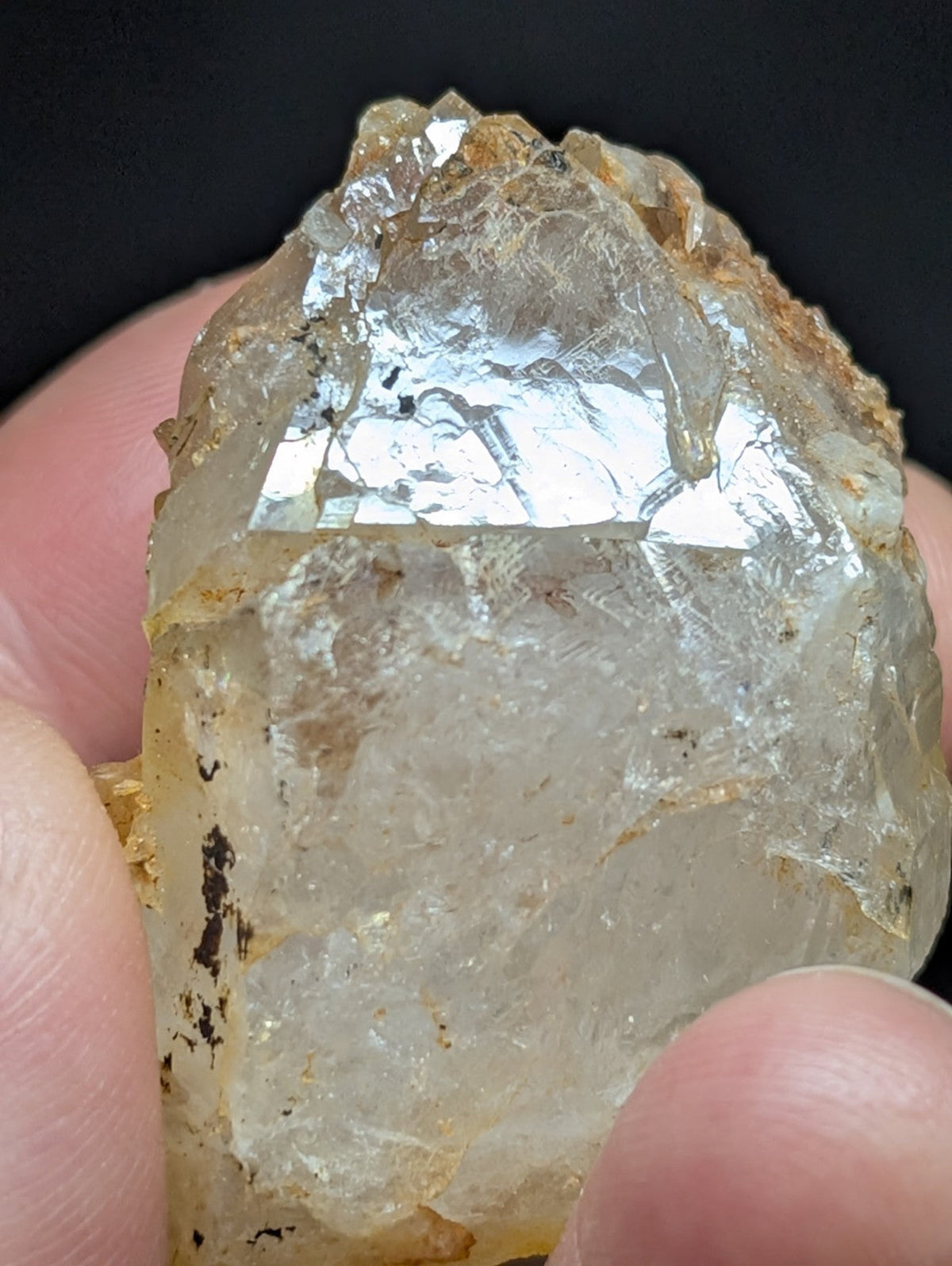 A translucent, pale yellowish quartz crystal with a rough, jagged surface and visible internal inclusions.