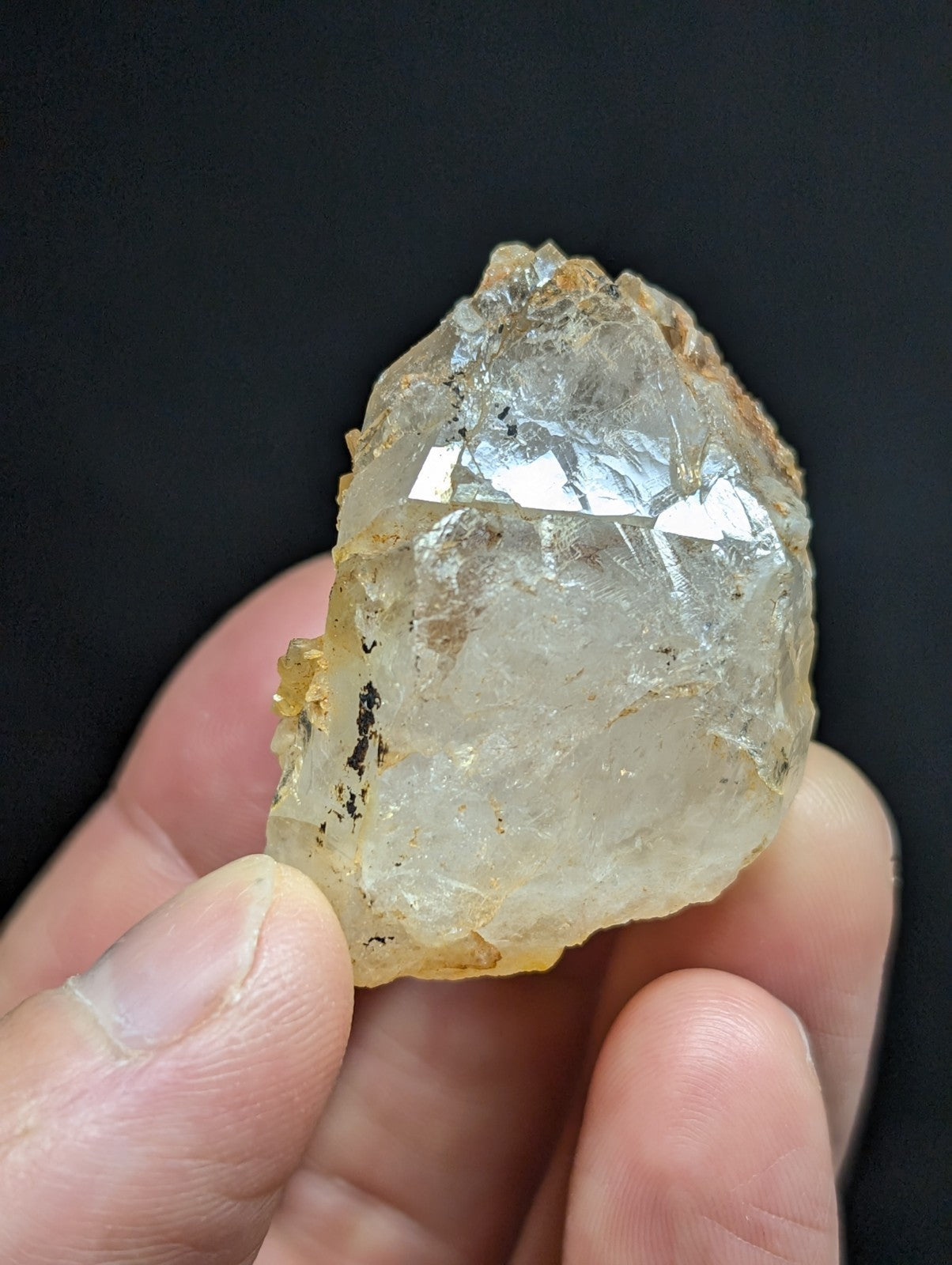 A translucent, pale yellowish quartz crystal with a rough, jagged surface and visible internal inclusions.