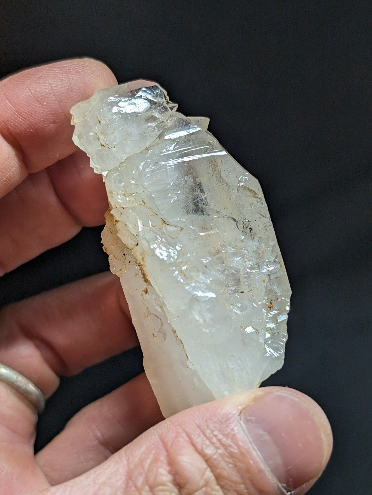 A translucent, clear quartz crystal with natural facets and subtle internal inclusions.