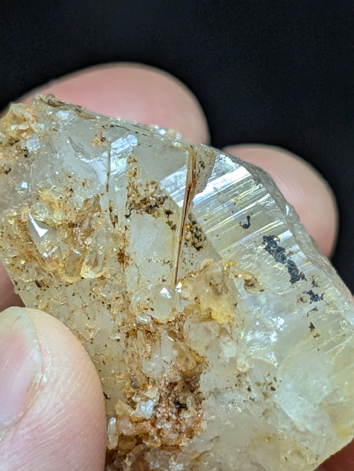 A translucent, pale yellowish crystal with visible internal inclusions and a rough, jagged surface.