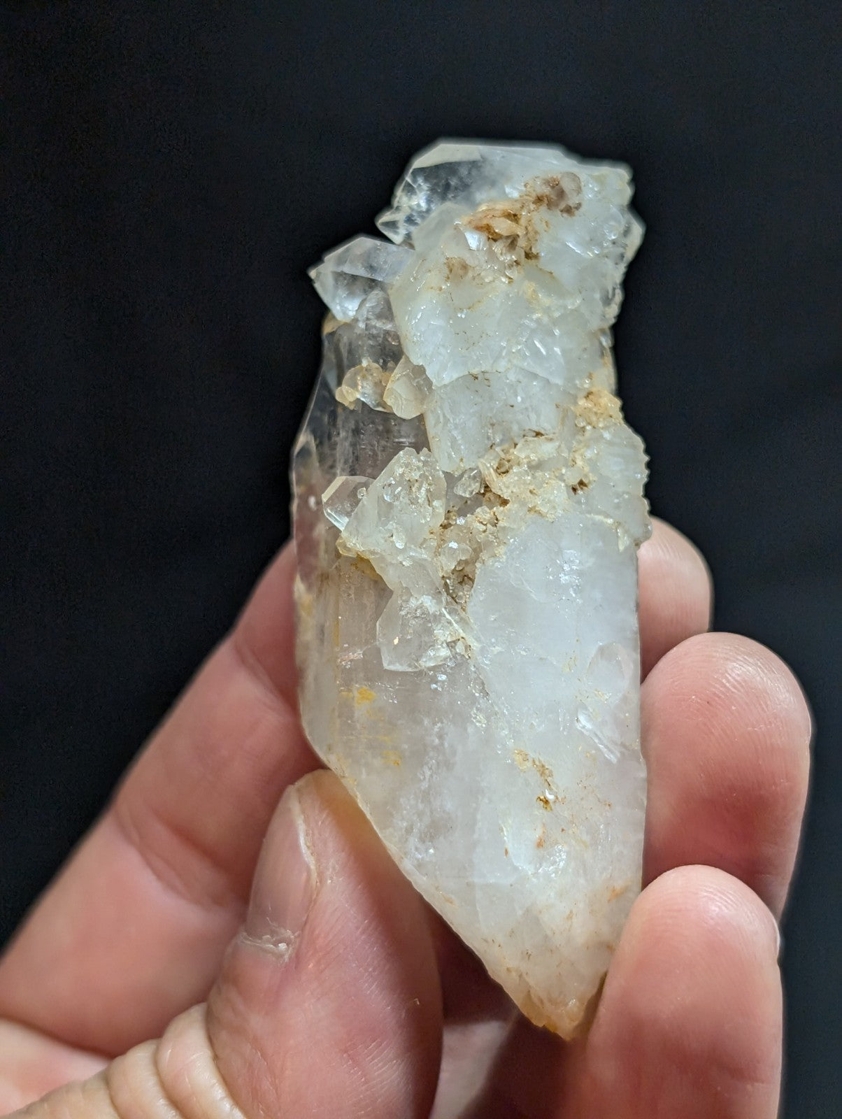 A translucent, clear quartz crystal cluster with natural imperfections and golden mineral inclusions.