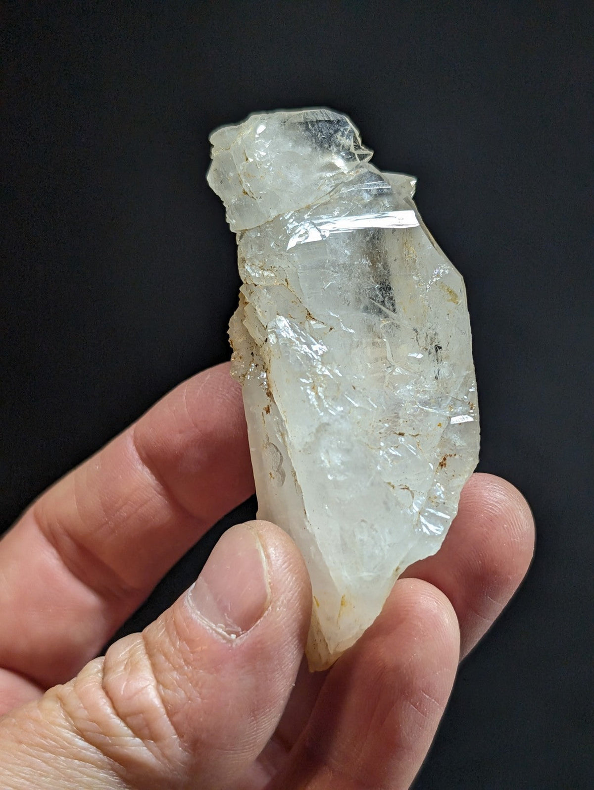 A translucent, clear quartz crystal with natural facets and minor inclusions.