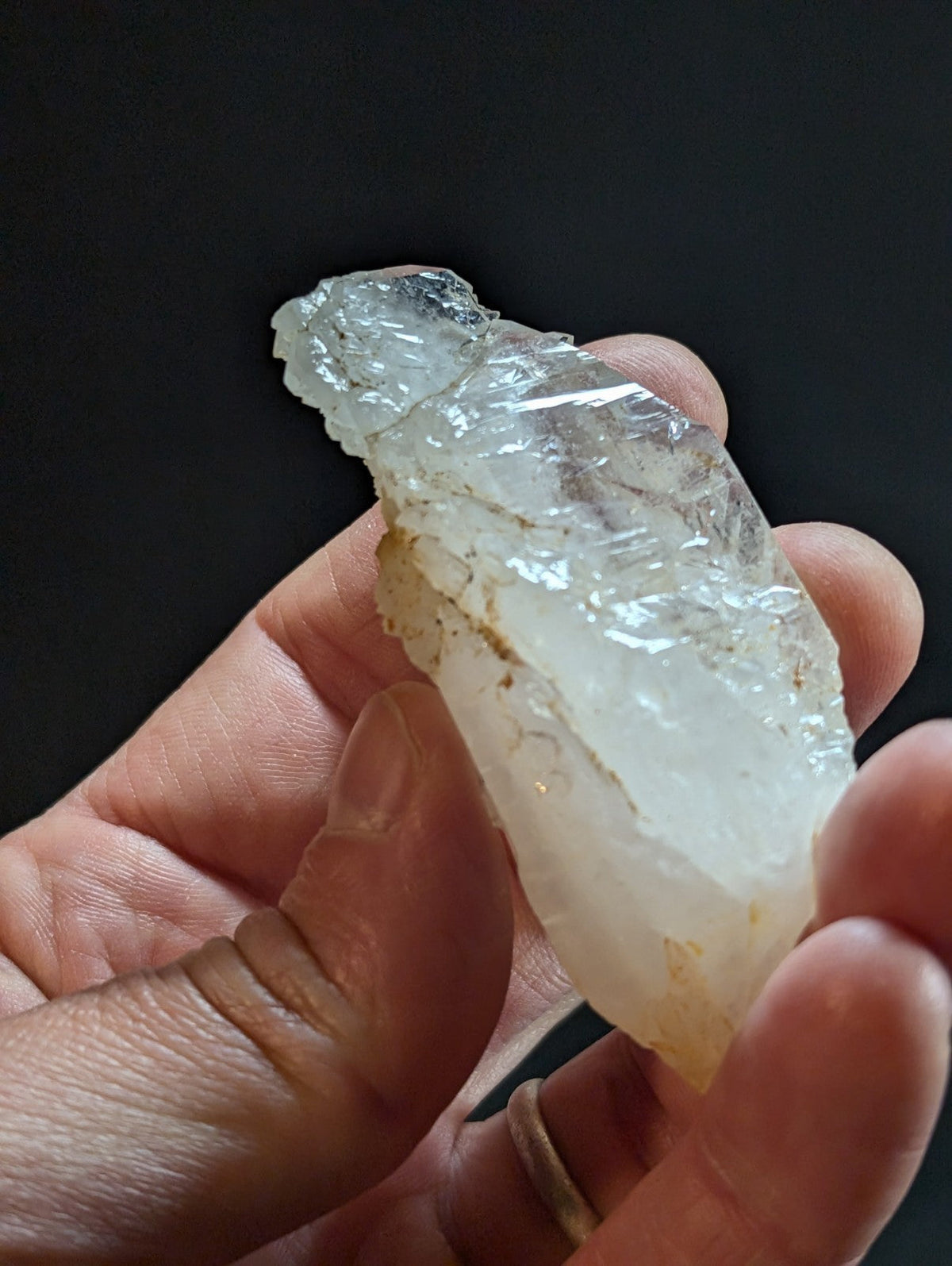 A translucent, irregularly shaped quartz crystal with a slightly milky white hue and visible internal inclusions.