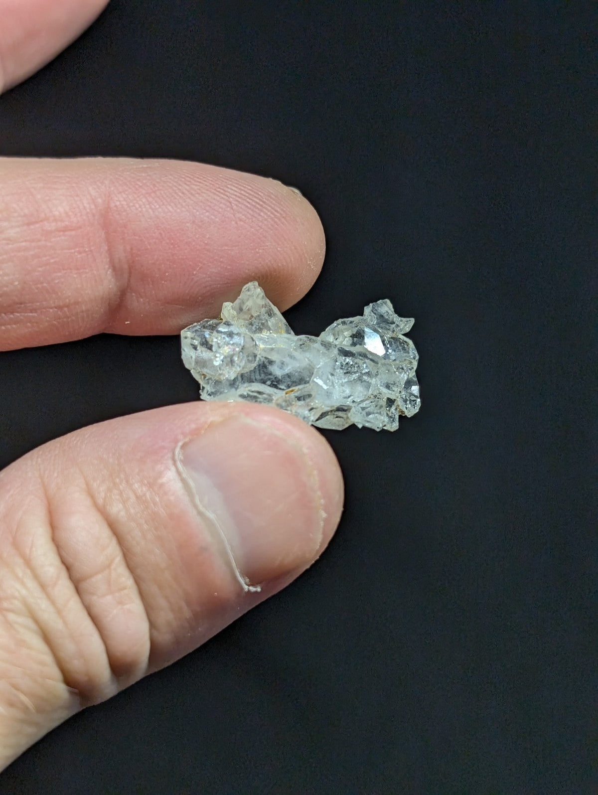 A translucent, crystalline mineral specimen with jagged edges and a pale blue-green hue.