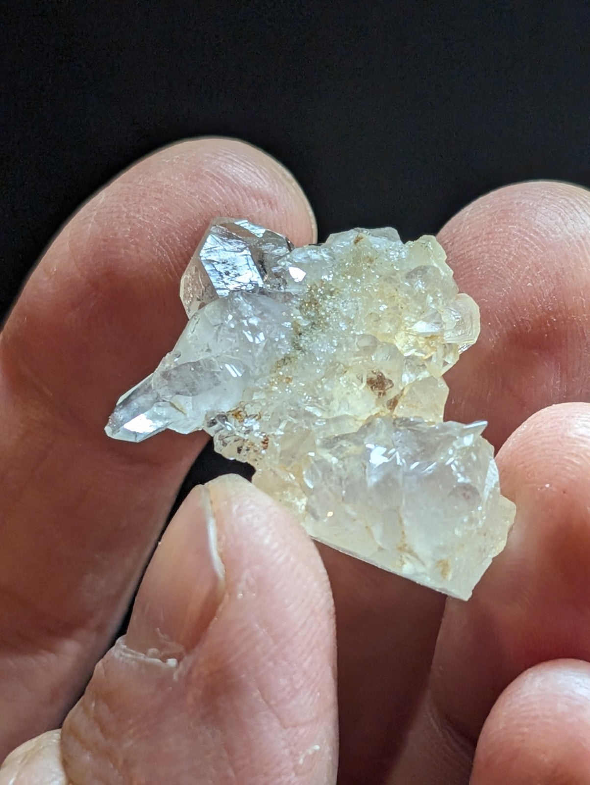 A translucent, crystalline mineral specimen with jagged edges and a pale yellowish tint.