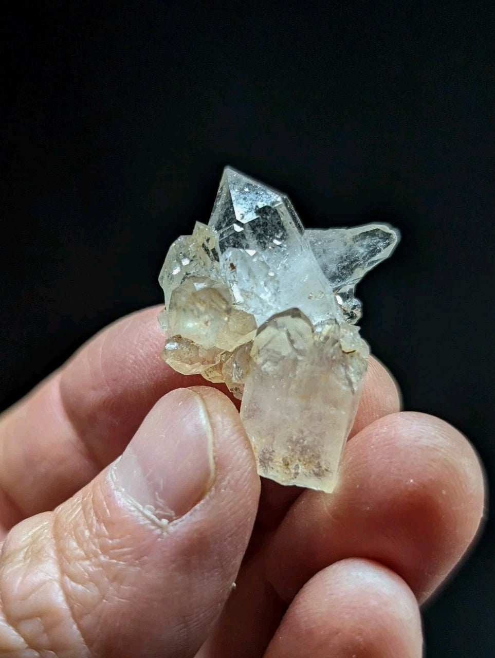A translucent, clear quartz crystal cluster with a mix of transparent and slightly cloudy sections.