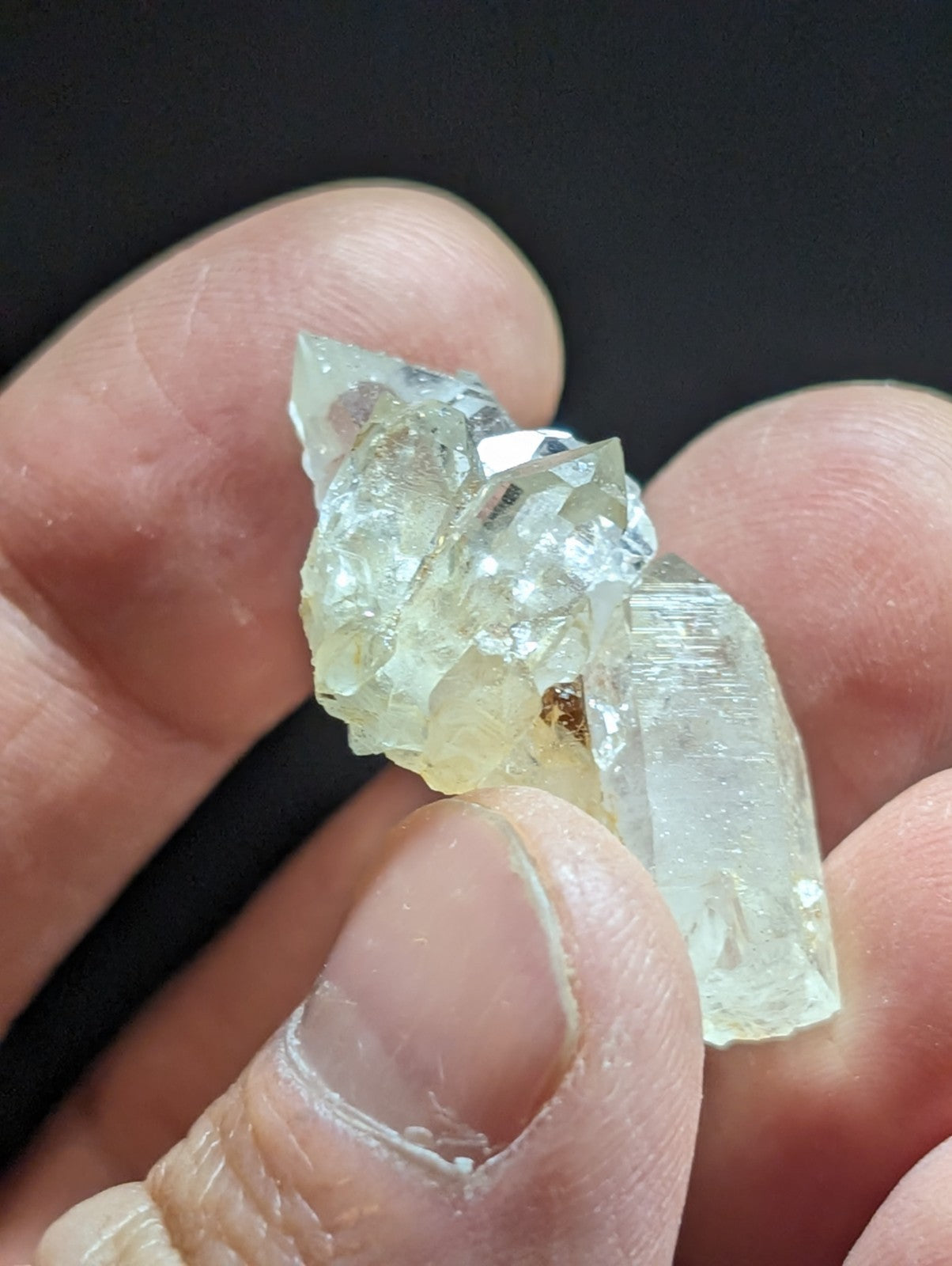 A translucent, pale yellow crystal cluster with sharp facets and a slightly cloudy appearance.