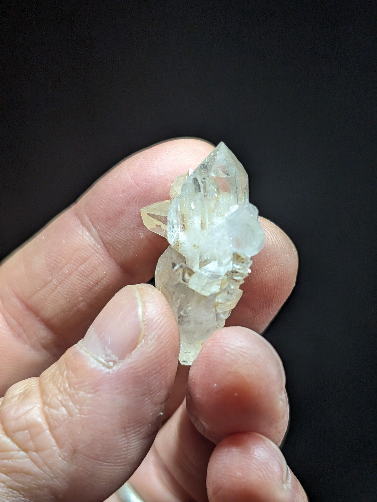 A translucent, pale quartz crystal cluster with sharp geometric facets and a slightly cloudy appearance.