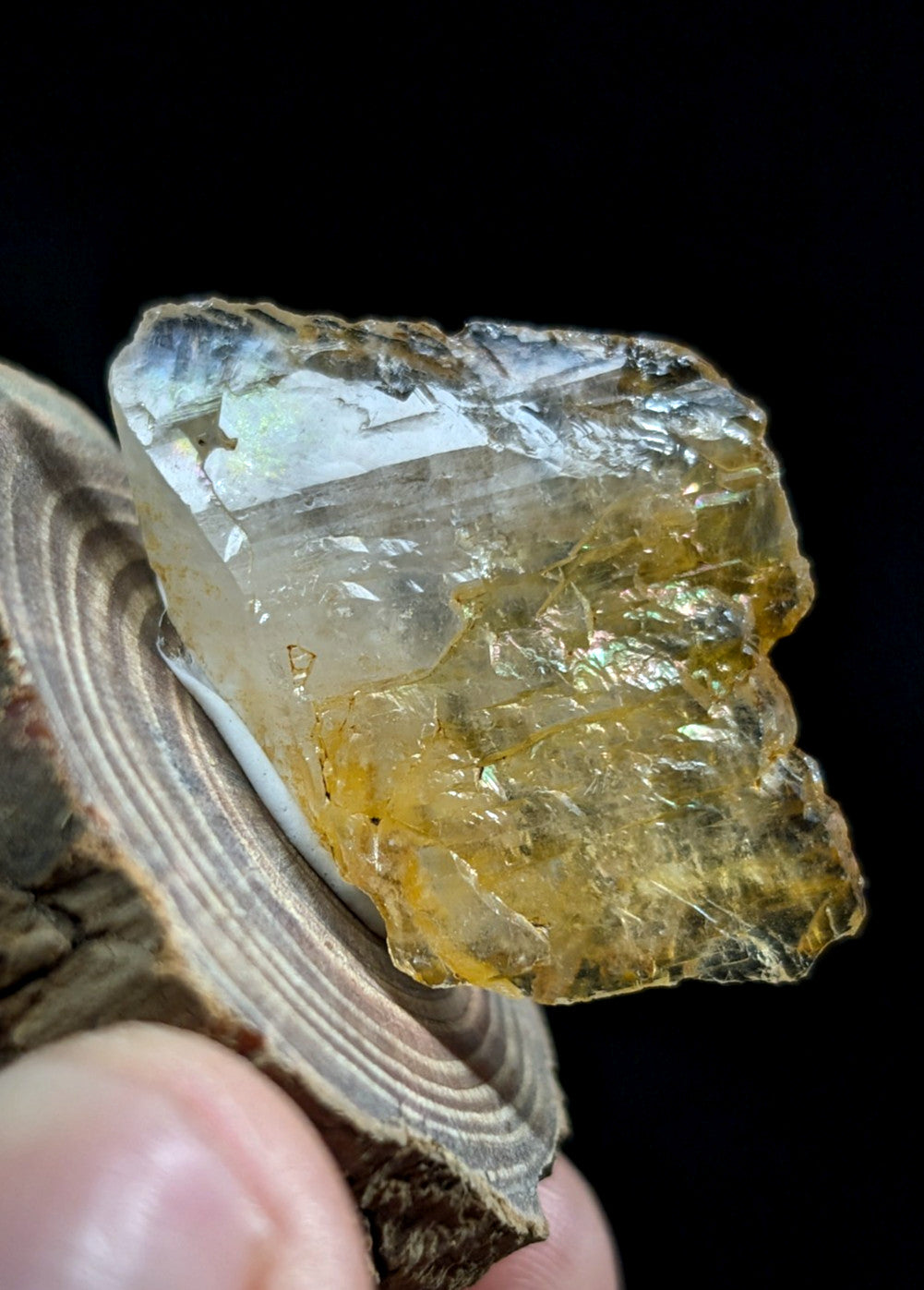A translucent yellow-orange crystal with a rough, jagged surface and visible internal inclusions.