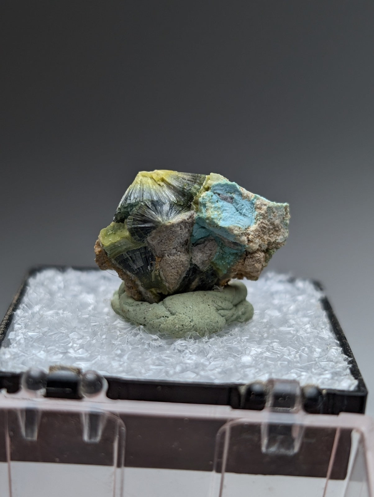 Unique wavellite mineral with vibrant yellow and teal crystals on rugged brown matrix from Garland County Arkansas