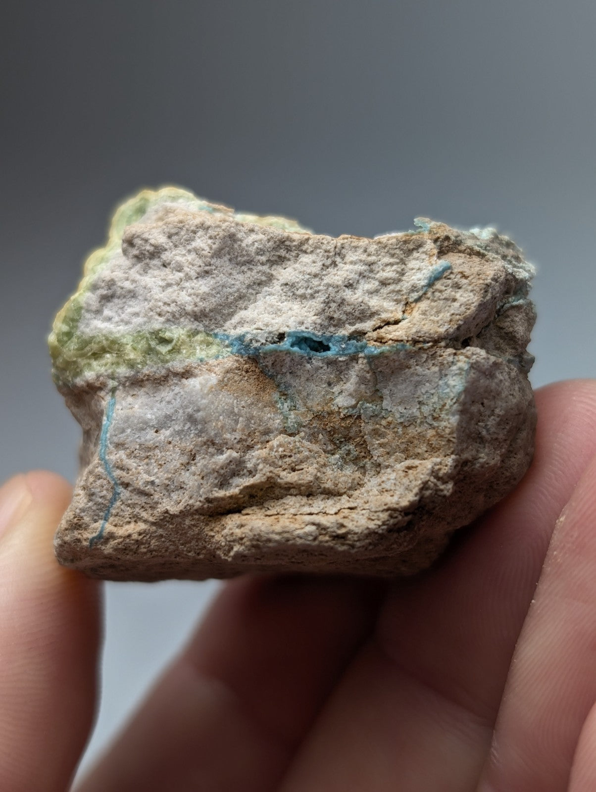 Unique wavellite mineral with near-turquoise blue veins on beige gray base with greenish-yellow patches from arkansas