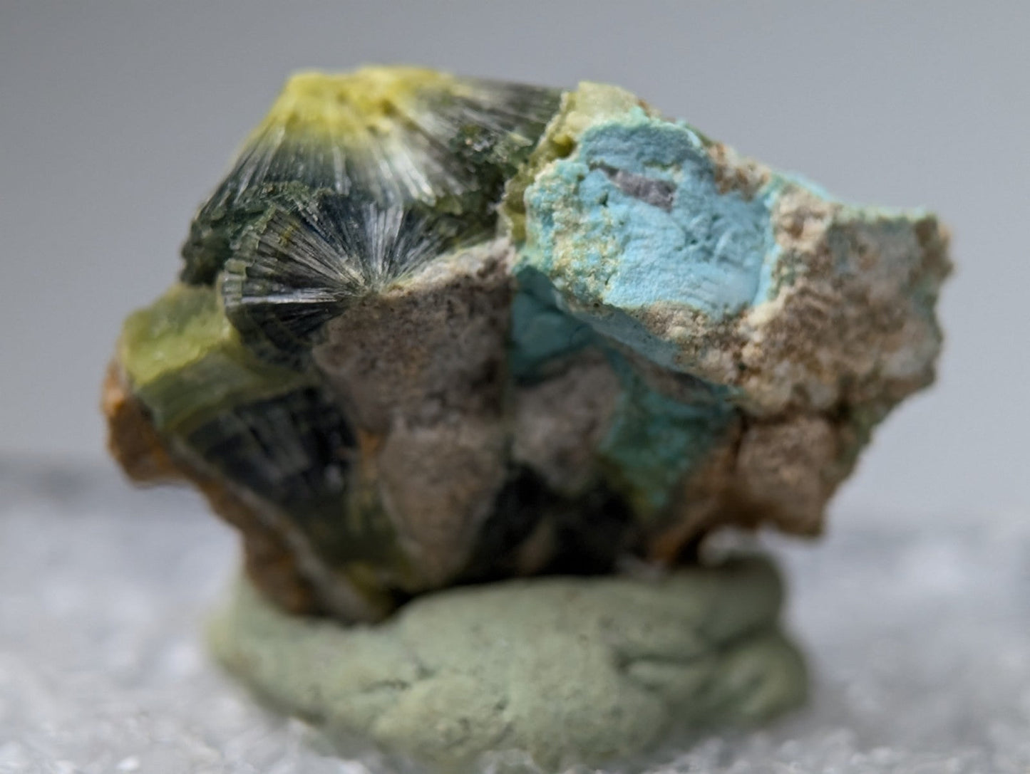 Unique wavellite mineral with a striking blue green patch and black crystals on rough matrix from Arkansas