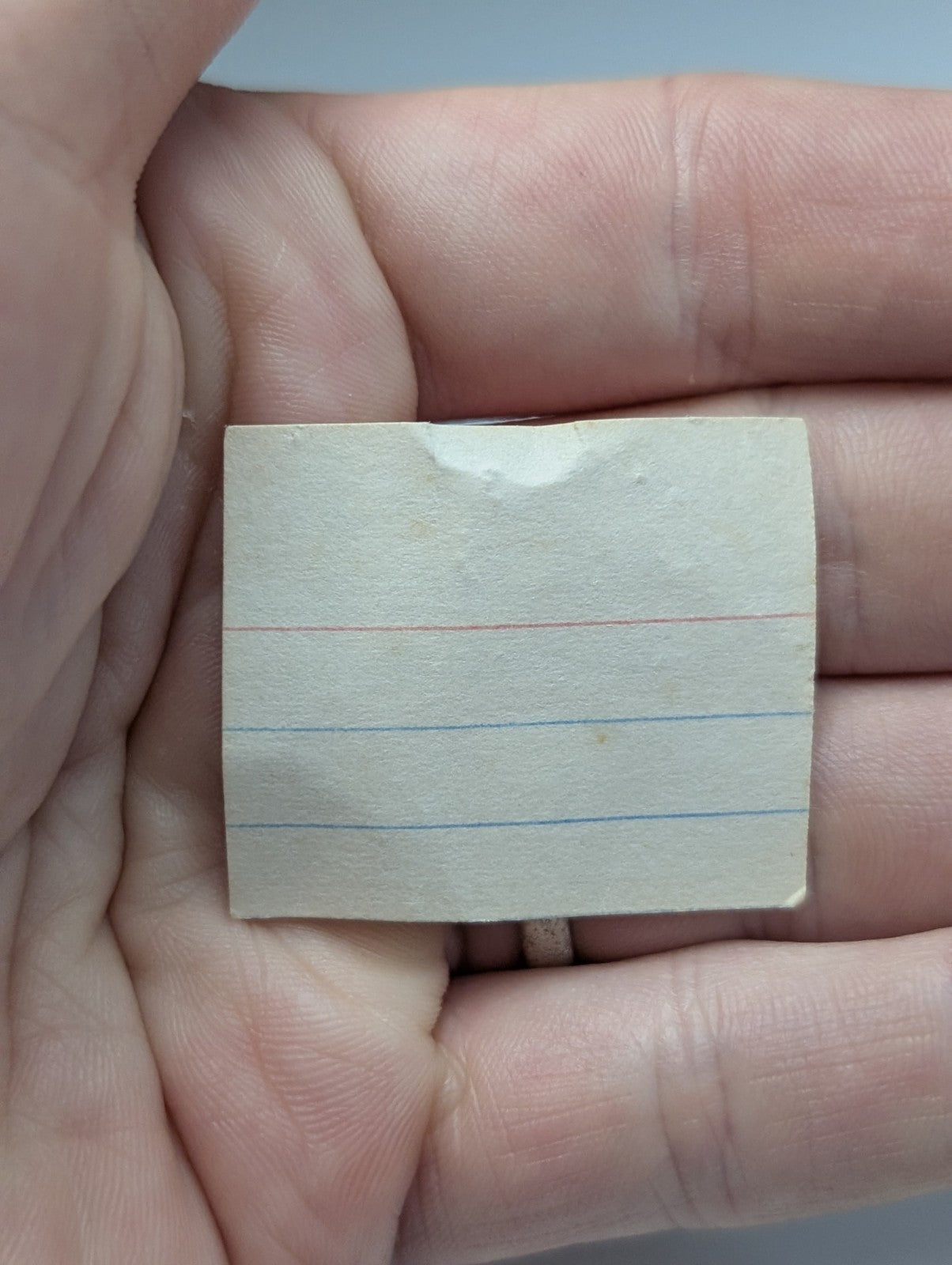 A slightly worn off-white lined notepad page with faint red and blue lines for unique wavellite near-turquoise notes