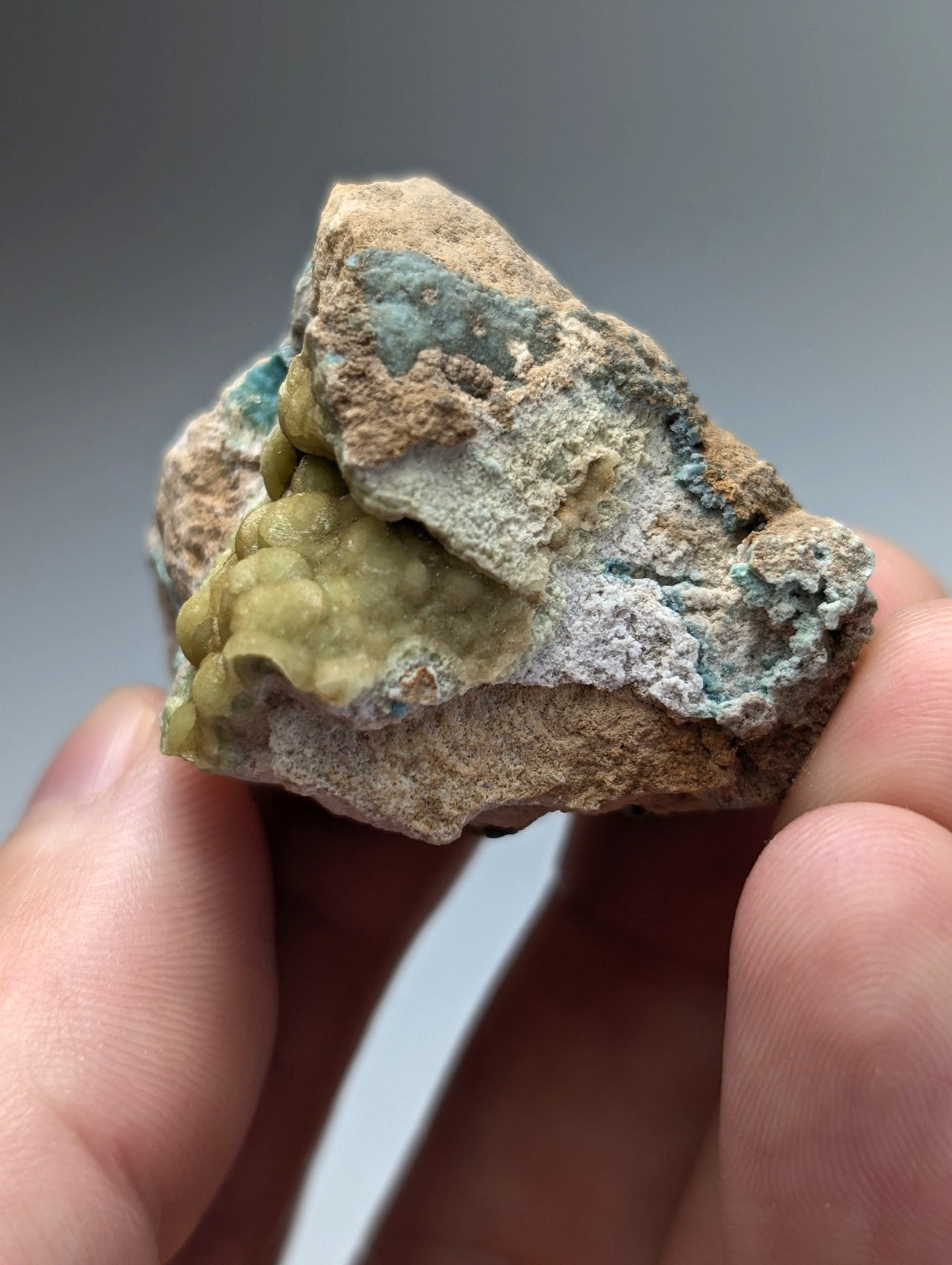 Unique wavellite mineral specimen with vibrant greenish-blue veining on rough brown matrix from garland county arkansas