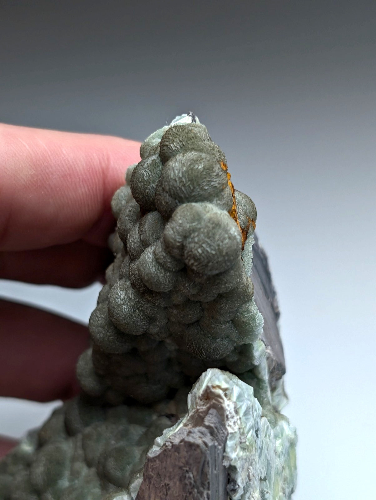 Uv reactive green wavellite cluster with bubble-like formations and small orange inclusion from mauldin mountain, arkansas