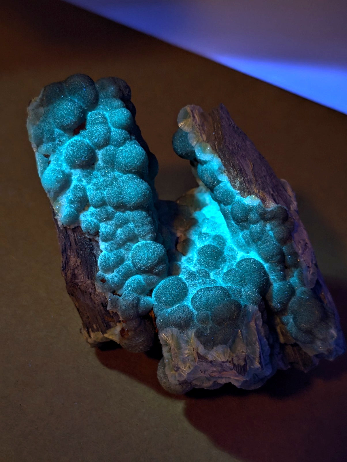 Uv reactive green wavellite cluster with blue green bubbly texture on earthy brown base from mauldin mountain arkansas usa