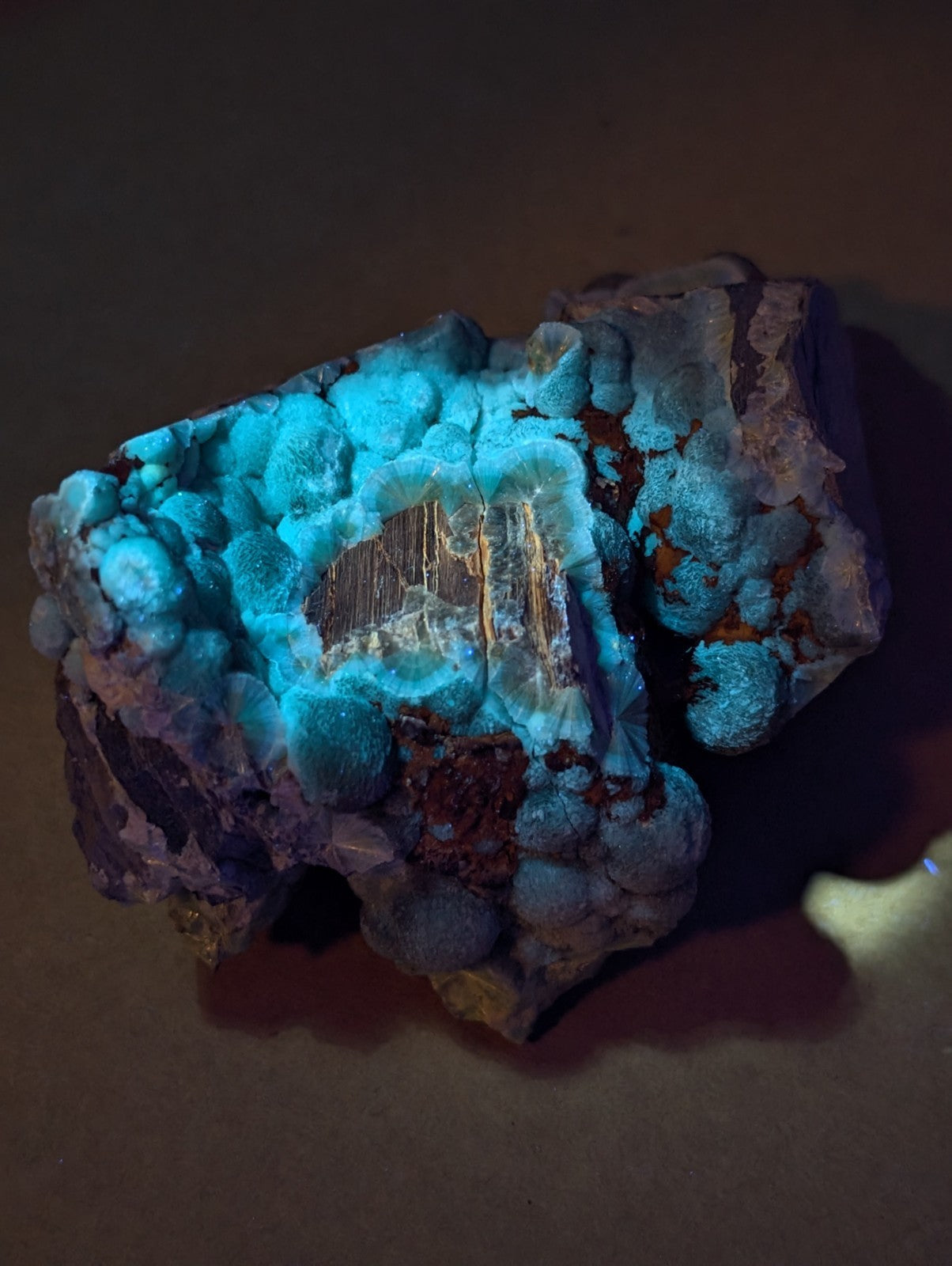 Uv reactive green wavellite cluster with turquoise-blue bubbly surface on brown and purple base from mauldin mountain arkansas usa