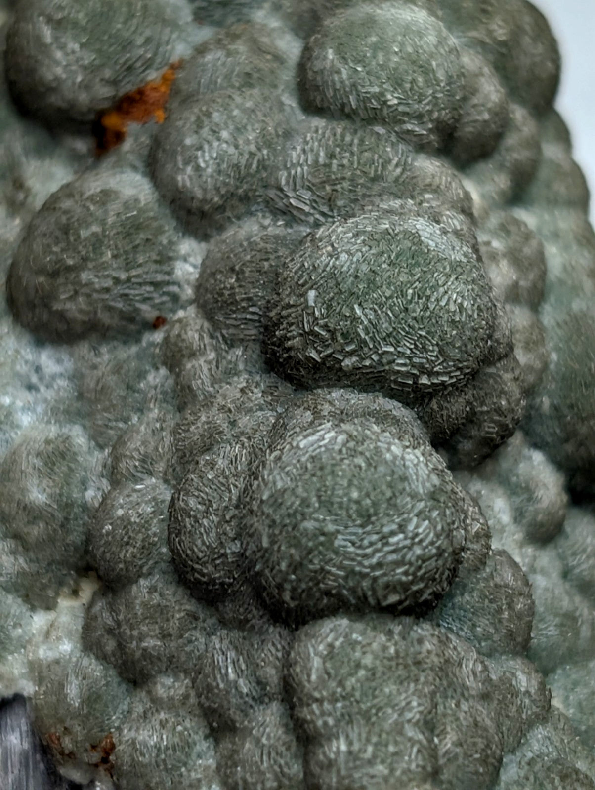 Uv reactive green wavellite cluster from mauldin mountain arkansas with gray textured mineral and rounded bulbous formations