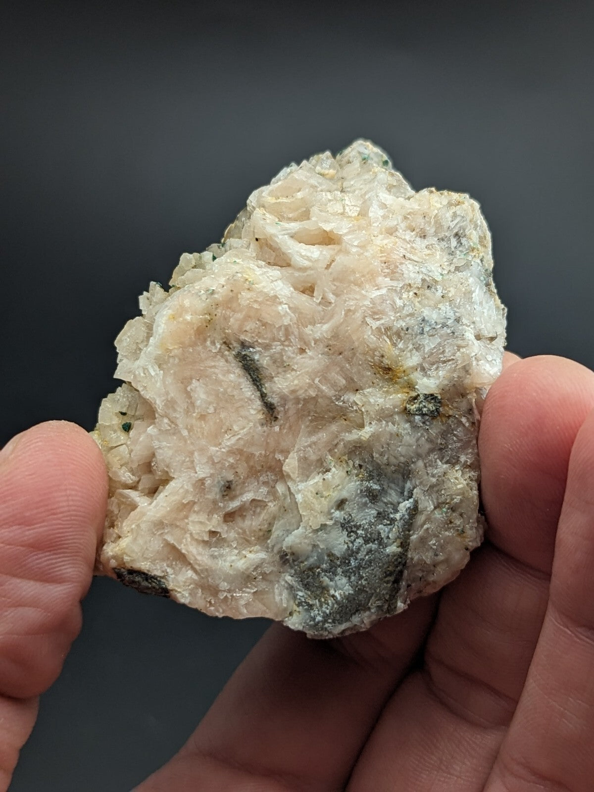 A translucent, crystalline mineral specimen with a mix of pale white and grayish hues, featuring intricate, jagged crystal formations.