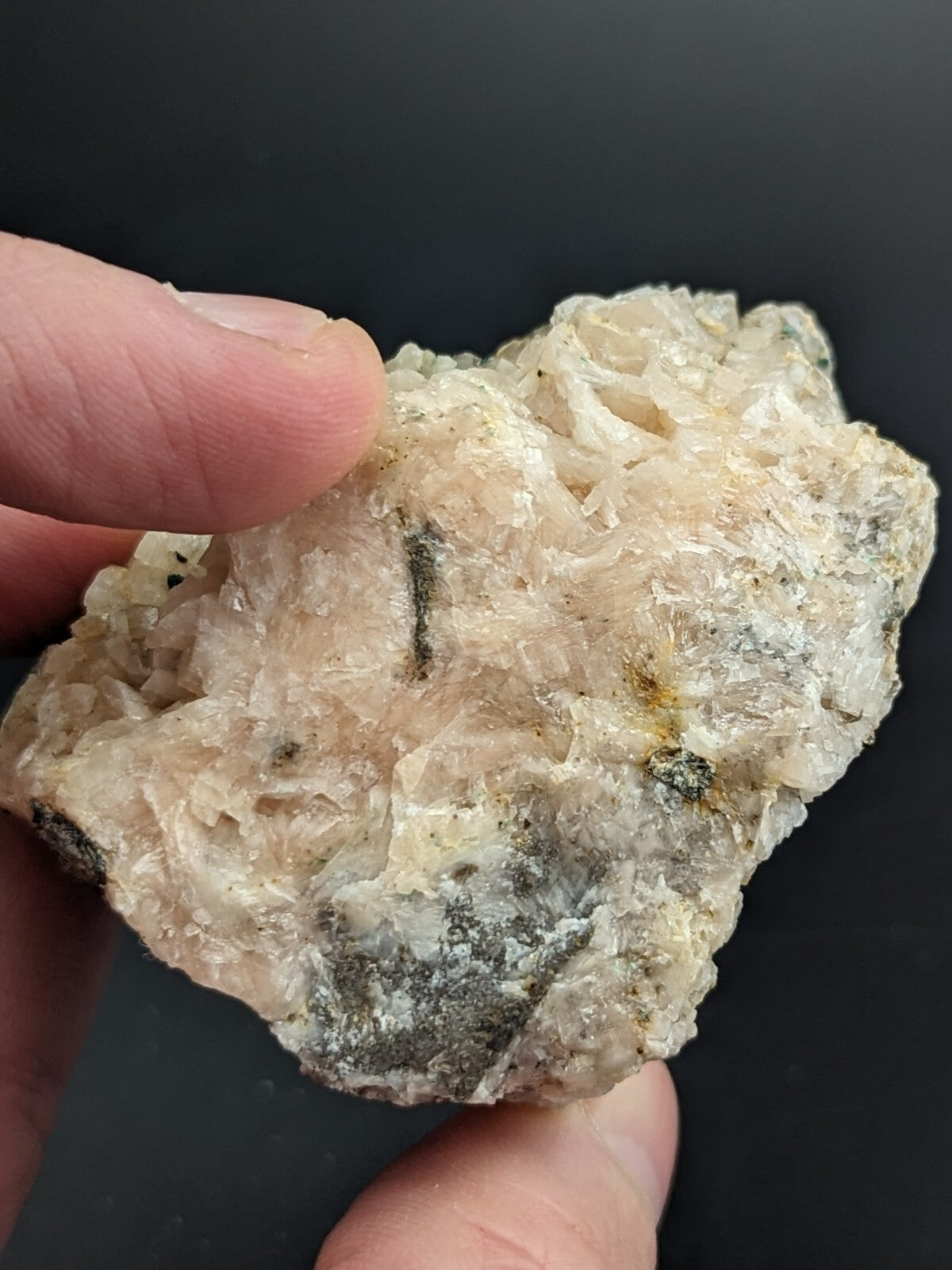A translucent, crystalline mineral specimen with a pale cream and grayish hue, featuring intricate intergrown crystals and subtle earthy inclusions.